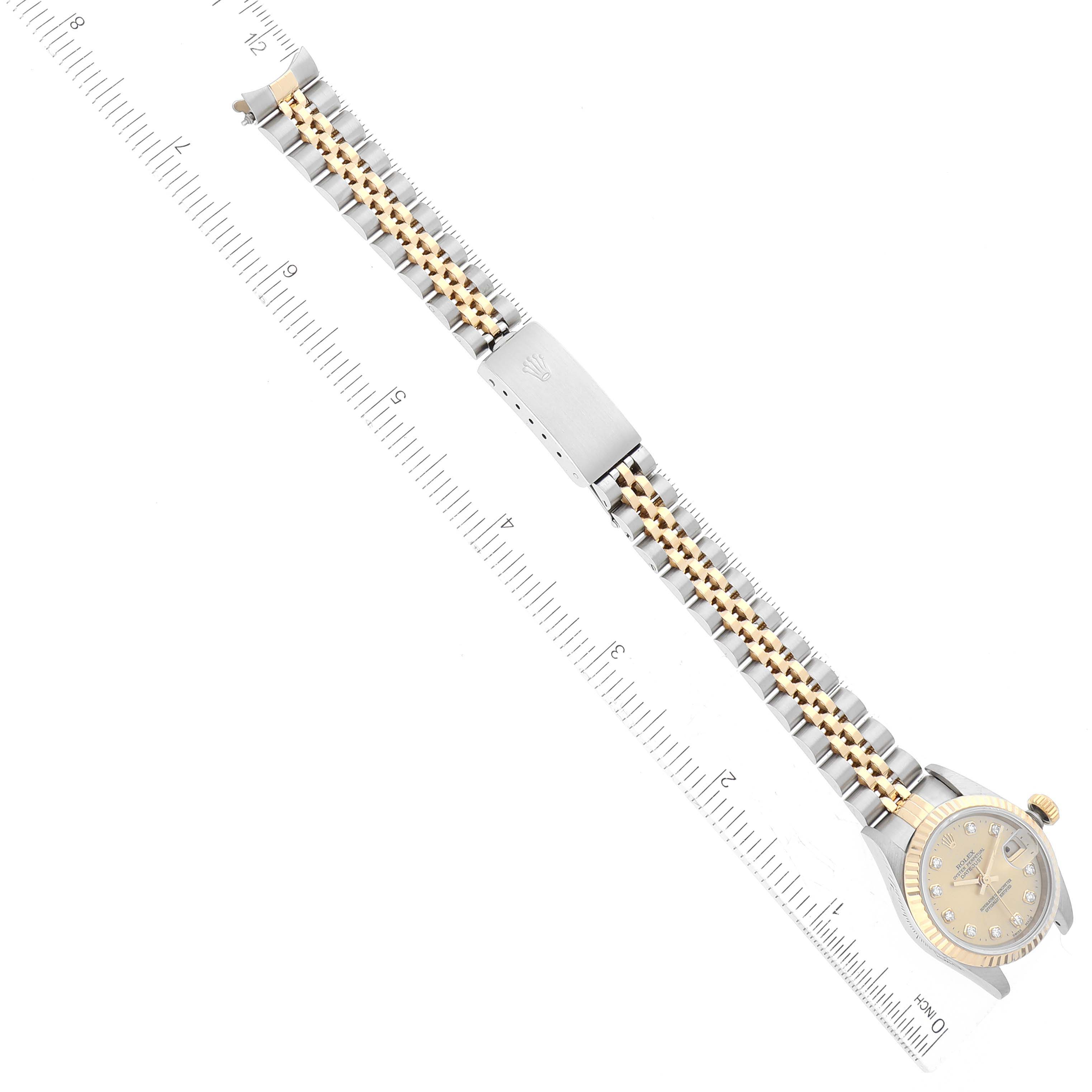 The image shows a Rolex Datejust 69173 Women's Steel and Gold (two tone) Champagne Dial 69173 Women's Steel and Gold (two tone) Champagne Dial watch from a top-down angle, highlighting the face, bracelet, clasp, and a ruler for scale.