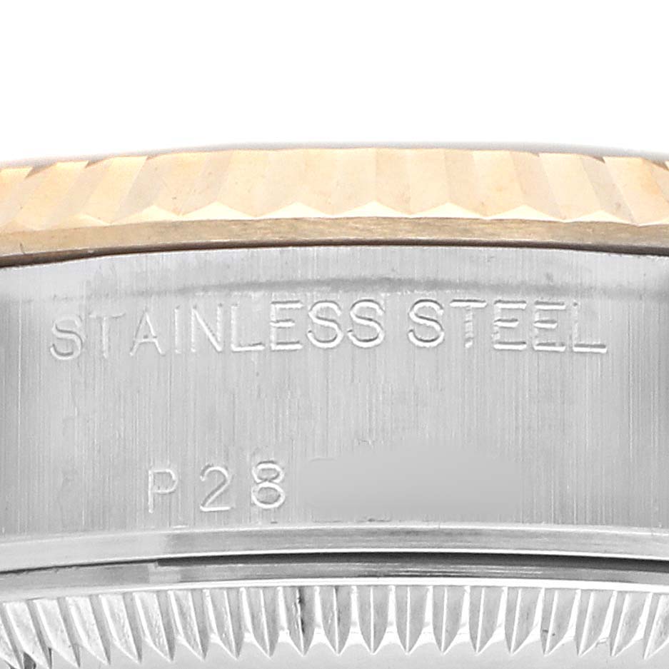 The image shows a close-up of the side of a Rolex Datejust 79173 Women's Steel and Gold (two tone) Champagne Dial, highlighting the stainless steel marking and fluted bezel.