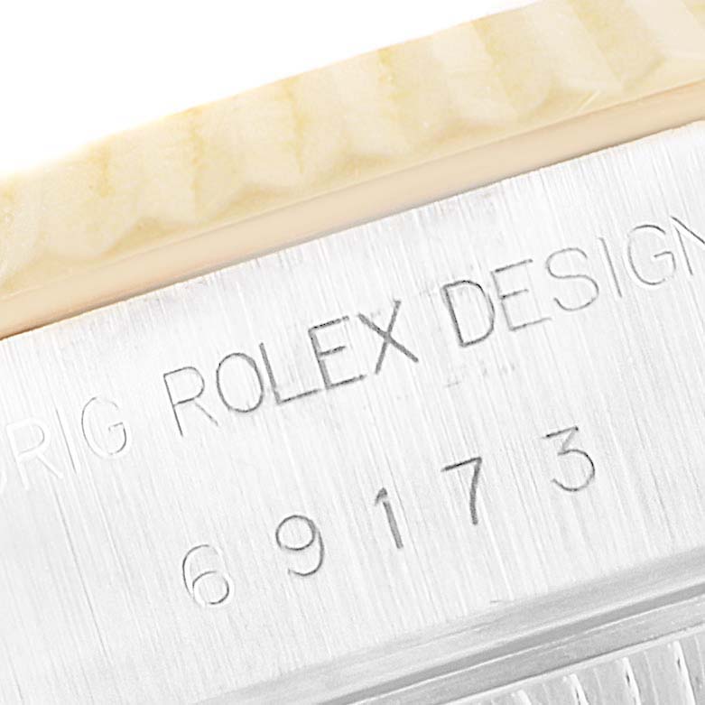 This image shows a close-up of the engraving on the side of a Rolex Datejust 69173 Women
s Steel and Gold (two tone) White Dial 69173 Women
s Steel and Gold (two tone) White Dial case.