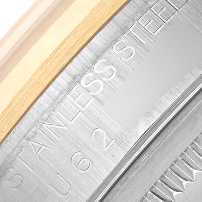 A close-up of the Rolex Datejust 16203 Men's Steel and Gold (two tone) Grey Dial 16203 Men's Steel and Gold (two tone) Grey Dial's case back shows the engraved text "STAINLESS STEEL" and part of the fluted bezel.