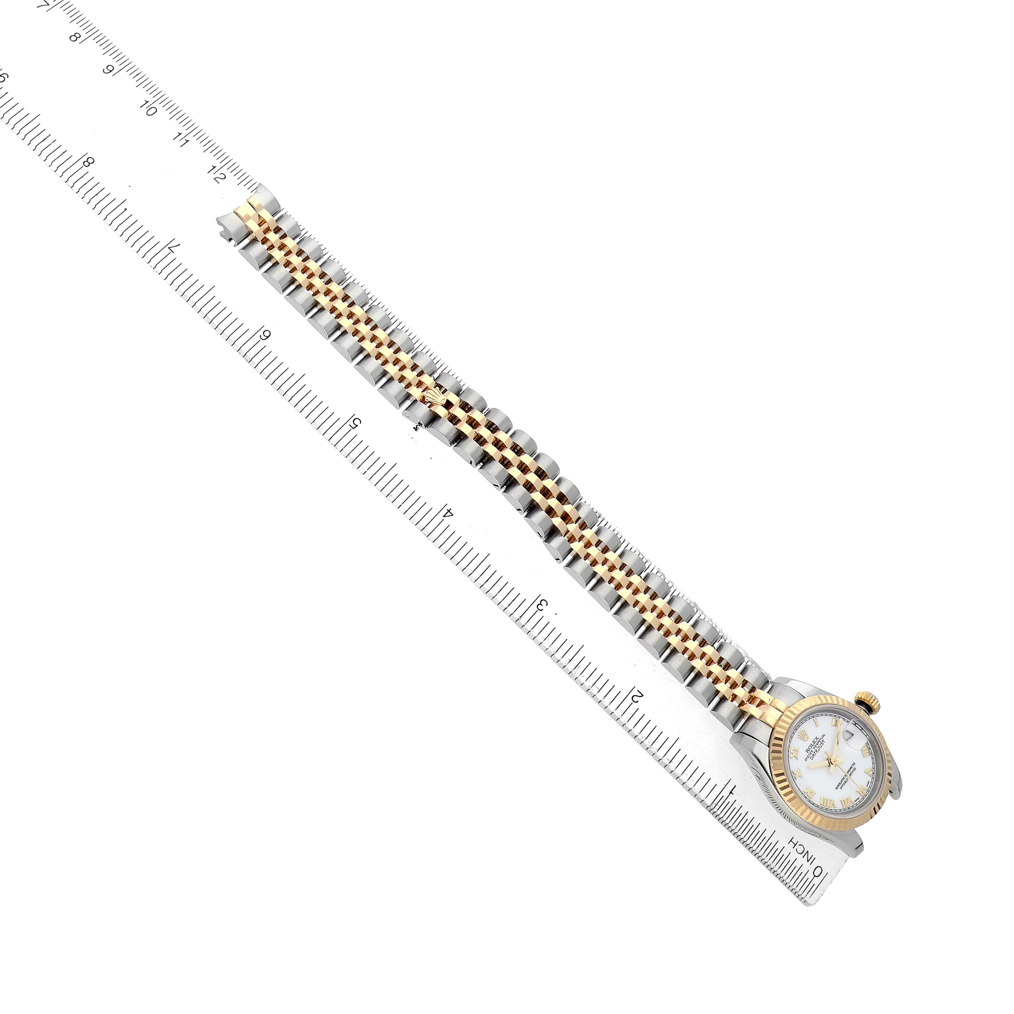 The Rolex Datejust 179173 Women's Steel and Gold (two tone) White Dial watch is shown at a side angle, displaying the bracelet and case, with a ruler for scale.