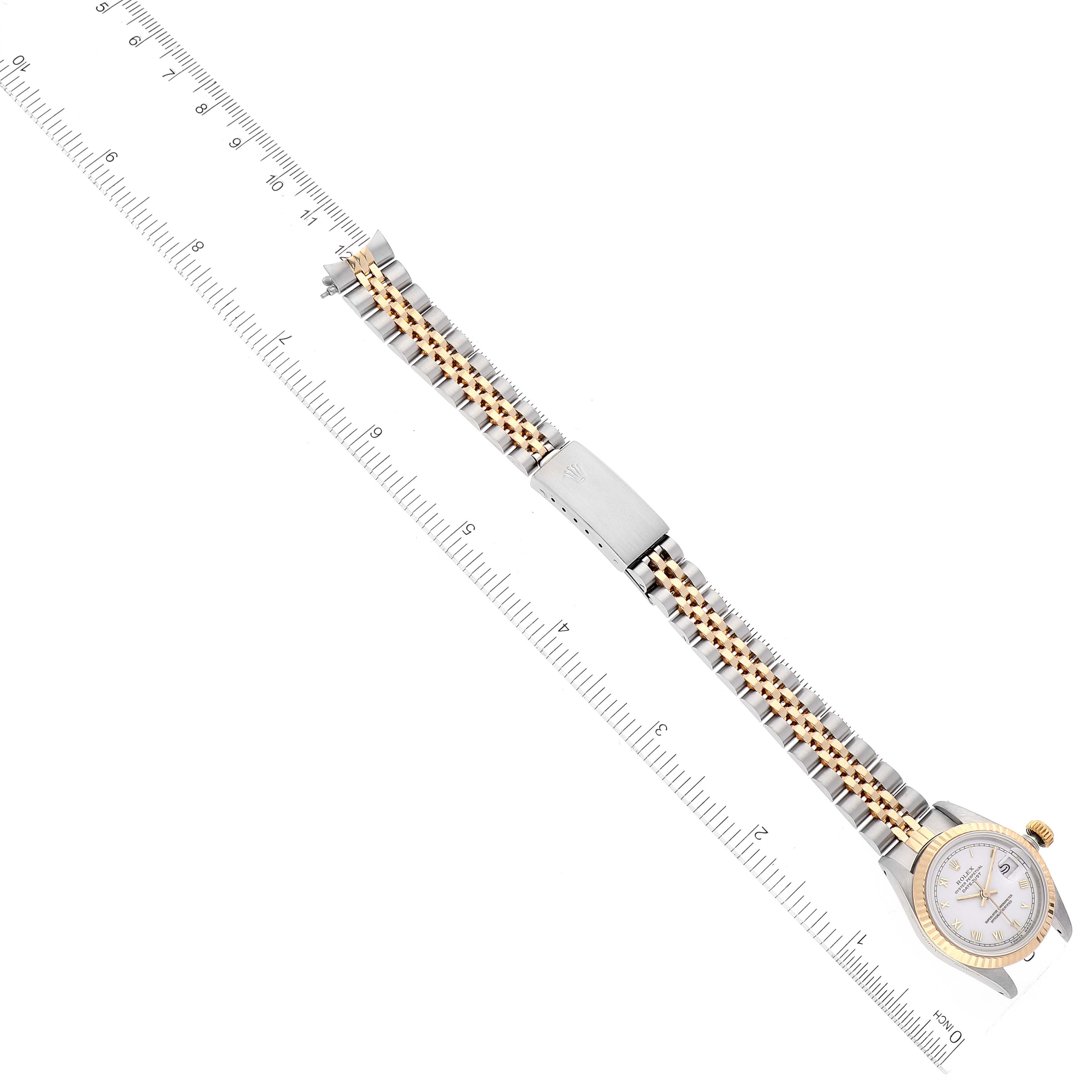 This is a top view of a Rolex Datejust 69173 Women's Steel and Gold (two tone) White Dial 69173 Women's Steel and Gold (two tone) White Dial watch laying horizontally, showing the bracelet, clasp, case, dial, and bezel.