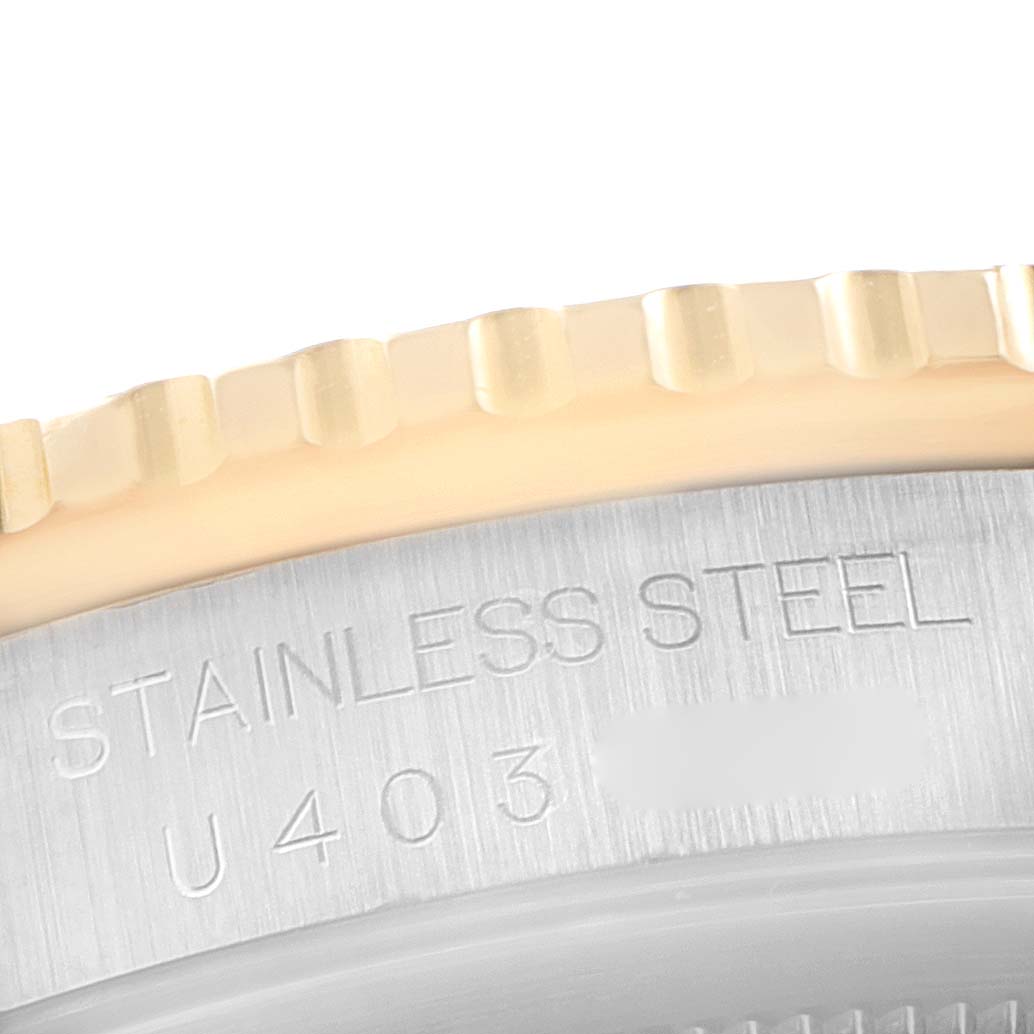 The image shows a close-up of the stainless steel casing and fluted bezel of a Turn-o-Graph Rolex watch.