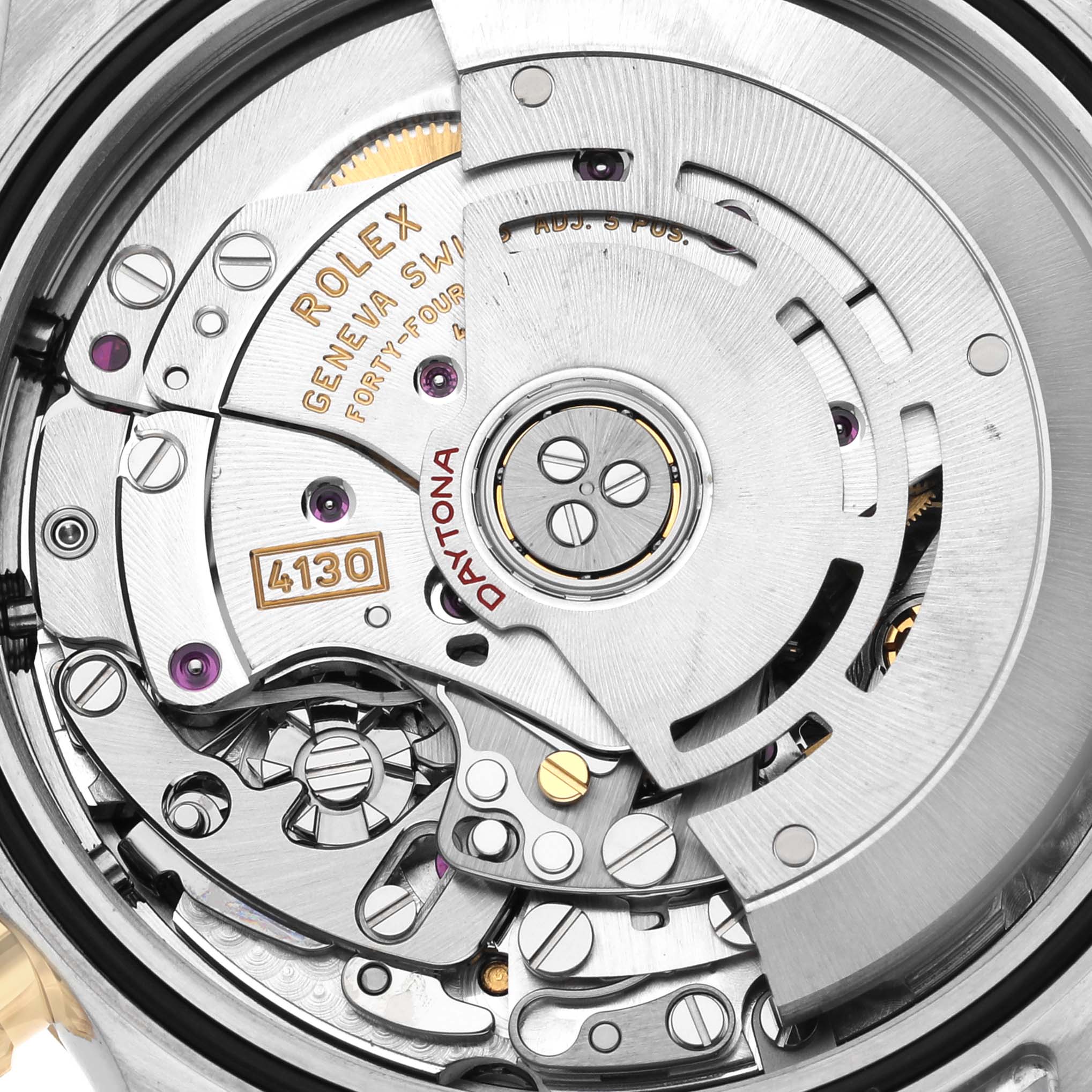 The image shows a close-up of the Rolex Daytona 116503 Men's Steel and Gold (two tone) Mother of Pearl Dial 116503 Men's Steel and Gold (two tone) Mother of Pearl Dial's movement, highlighting gear details and inscriptions.