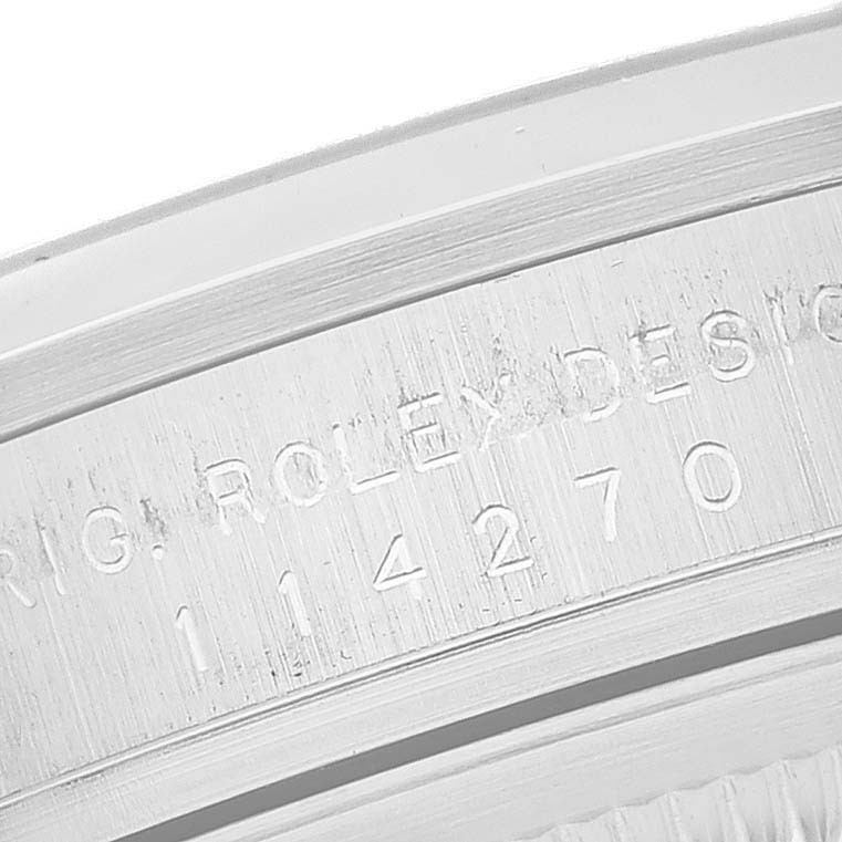 This close-up image shows the engraved model number and "Rolex Design" text on the case of a Rolex Explorer 114270 Men
s Stainless Steel Black Dial 114270 Men
s Stainless Steel Black Dial watch.