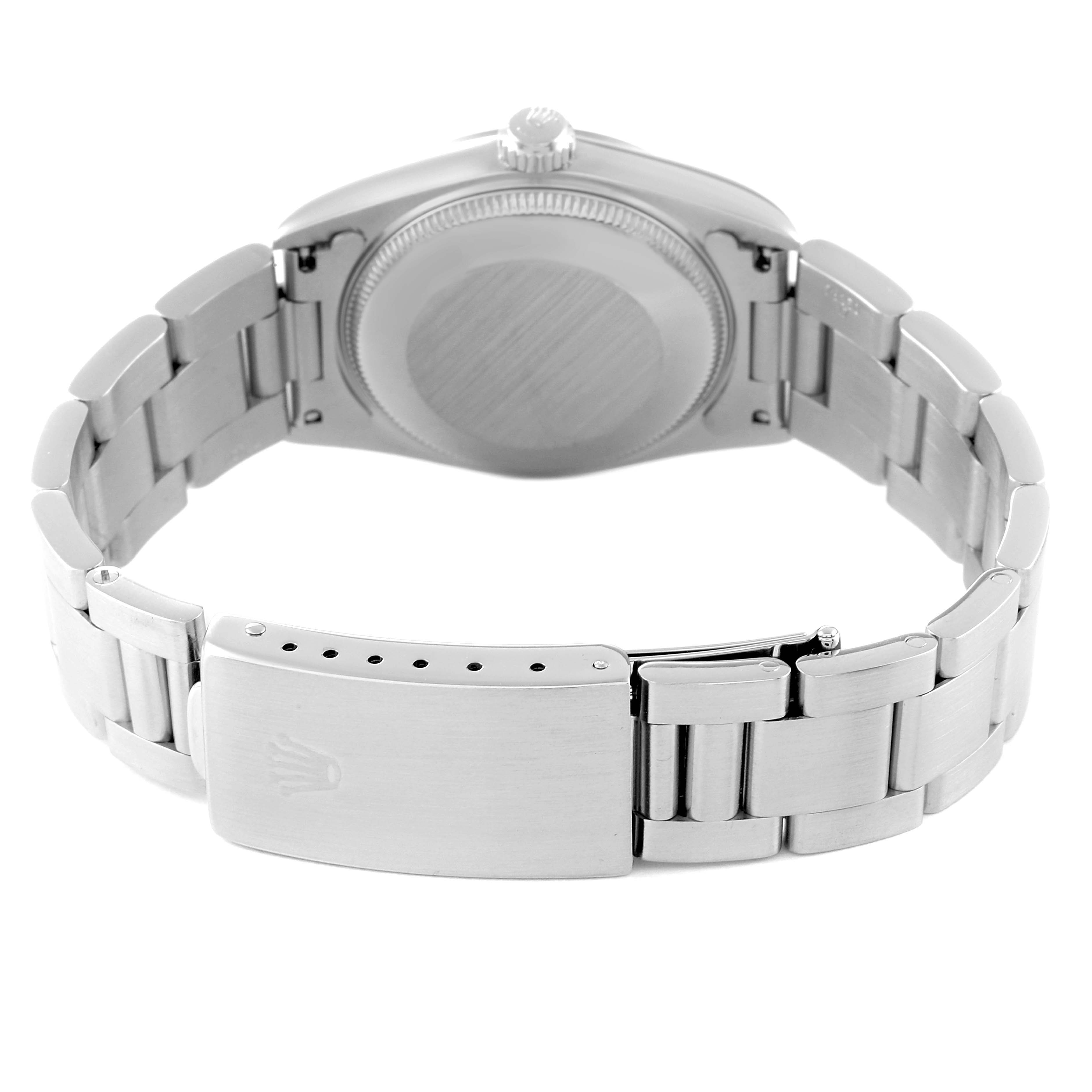 The image shows the back and clasp of a Mid-Size Rolex watch, highlighting its bracelet and case back.