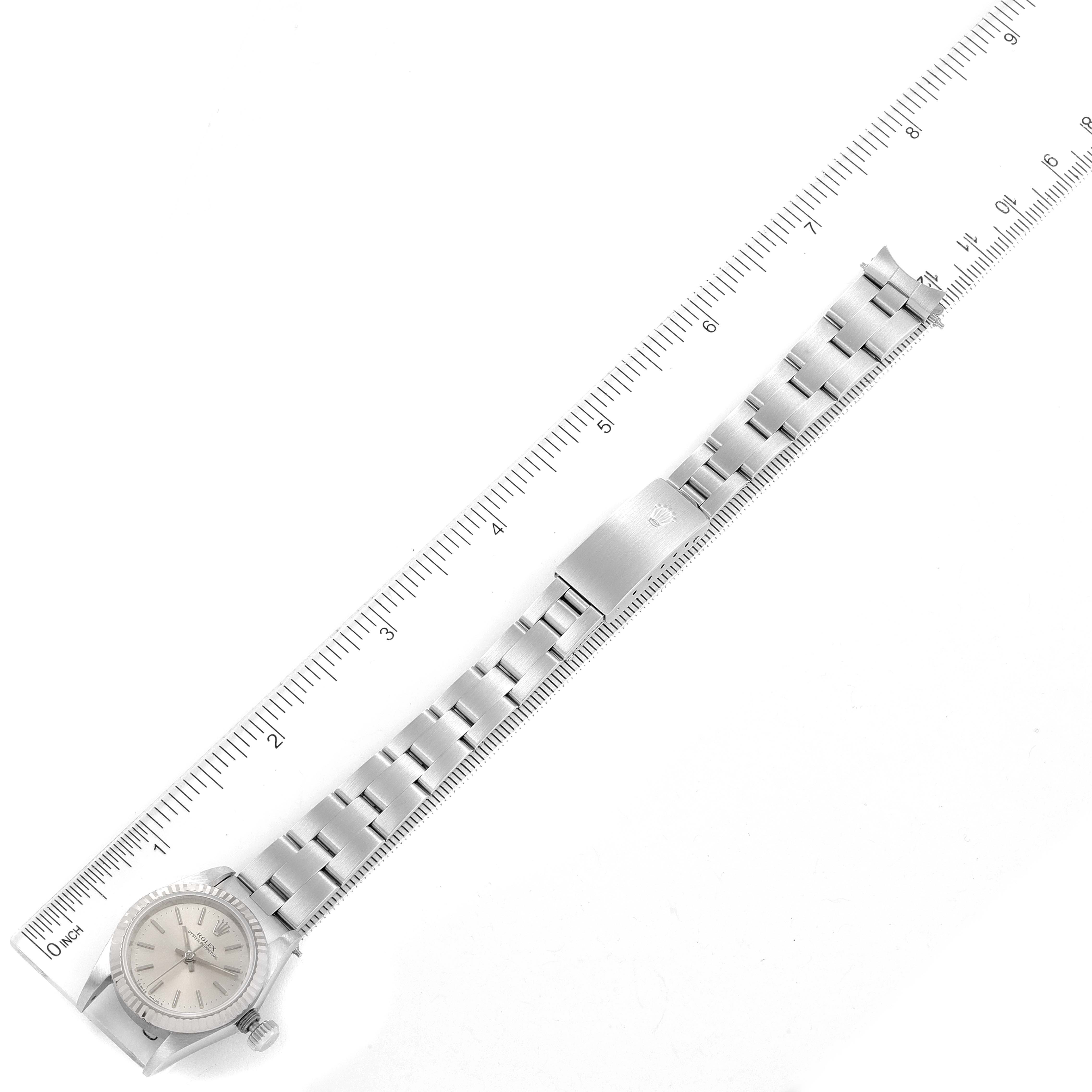 The image shows a Rolex Oyster Perpetual 67194 Women's Stainless Steel Silver Dial 67194 Women's Stainless Steel Silver Dial watch laid flat alongside a ruler.