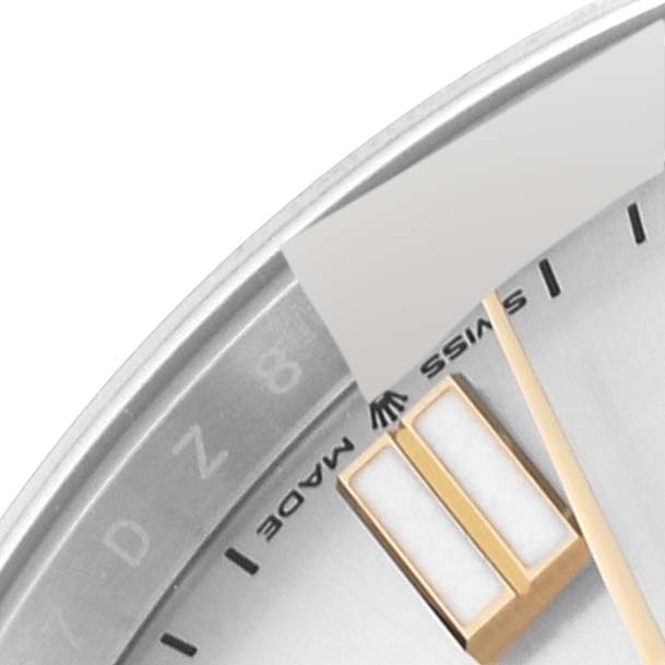 This close-up angle of a Rolex Oyster Perpetual 124300 Men's Stainless Steel Silver Dial 124300 Men's Stainless Steel Silver Dial watch shows part of the dial, one hand, and a portion of the hour markers.