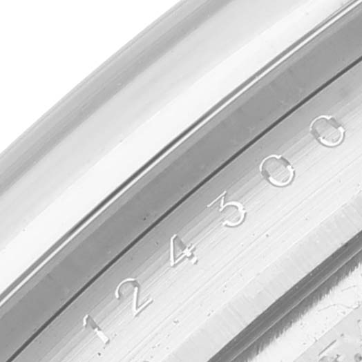 This close-up image shows the serial number engraving on the metal casing of a Rolex Oyster Perpetual 124300 Men's Stainless Steel Silver Dial 124300 Men's Stainless Steel Silver Dial watch.