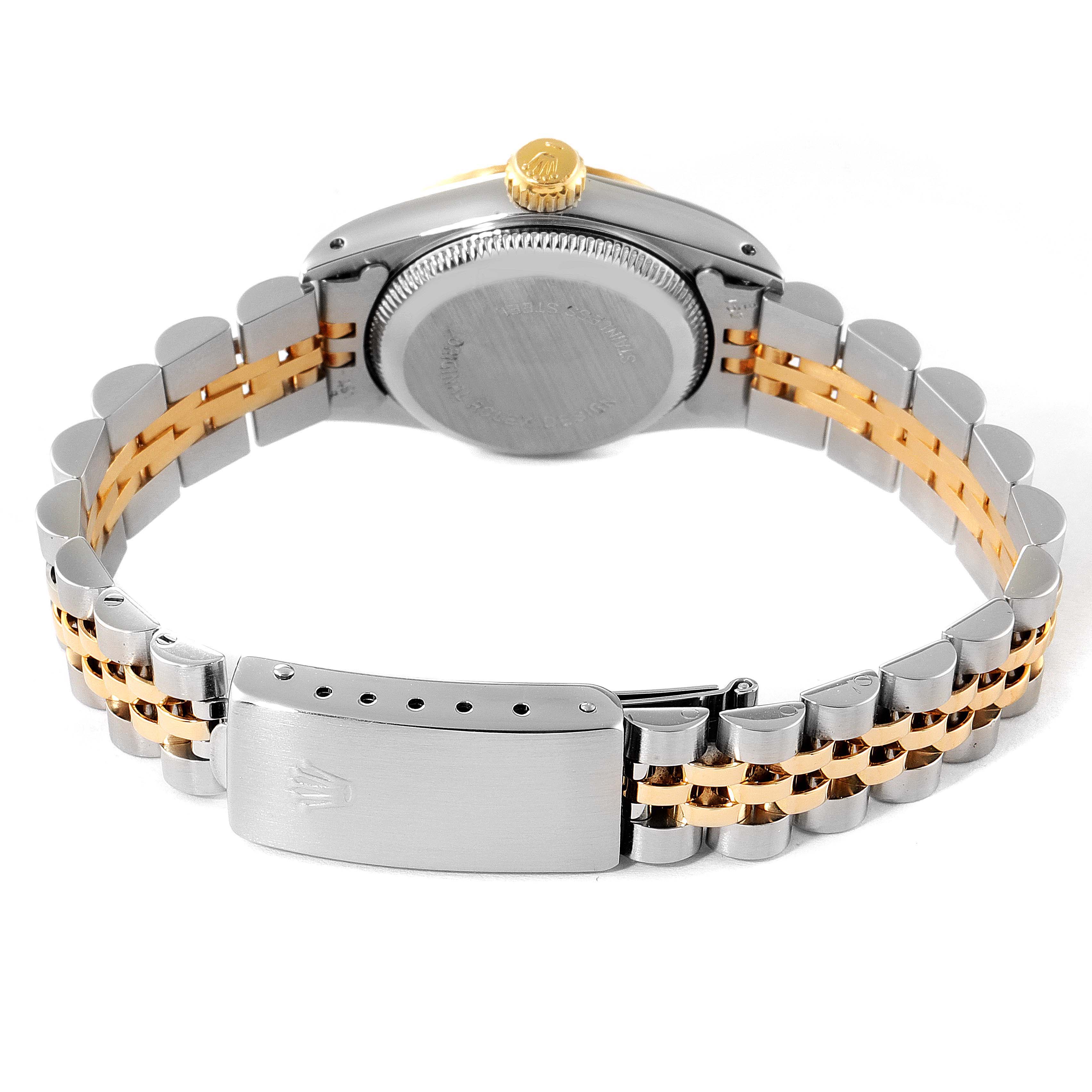 The image shows the back view of a Rolex Oyster Perpetual 67193 Women
s Steel and Gold (two tone) Champagne Dial 67193 Women
s Steel and Gold (two tone) Champagne Dial watch, highlighting its case back, crown, and two-tone metal bracelet.