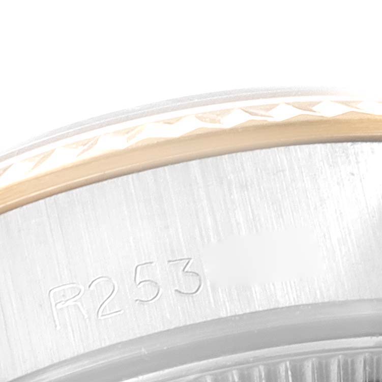 The image shows a close-up view of the bezel edge and part of the case back of a Rolex Oyster Perpetual 67193 Women's Steel and Gold (two tone) Champagne Dial 67193 Women's Steel and Gold (two tone) Champagne Dial watch.