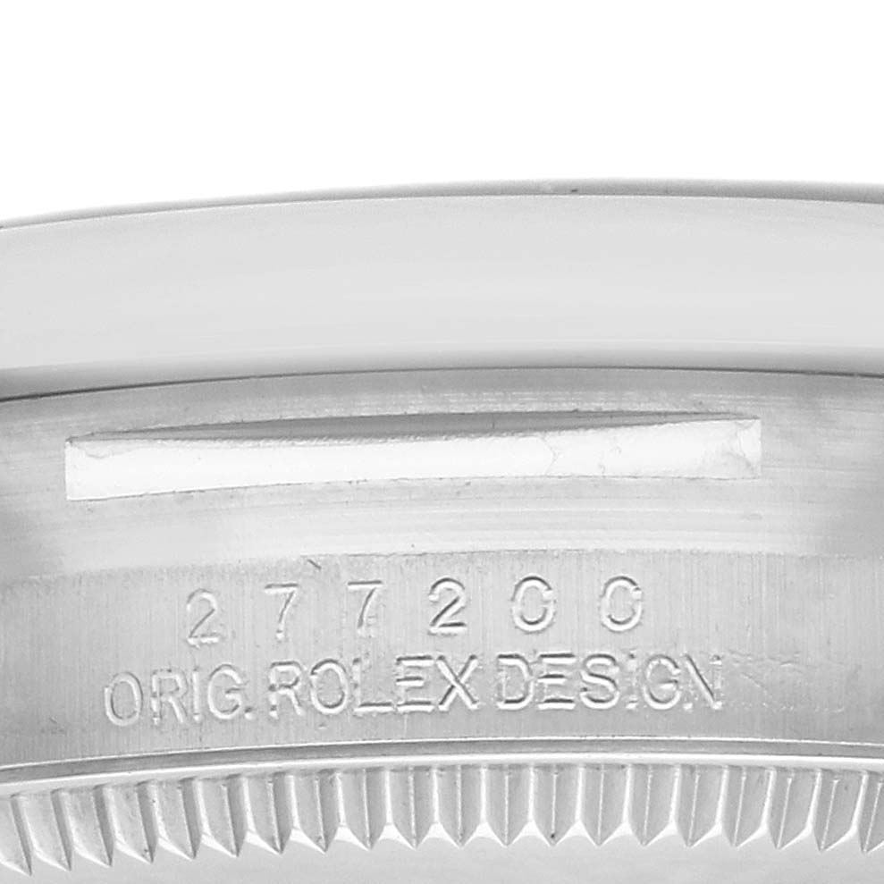 The image shows a close-up of the case side with engravings on the Rolex Oyster Perpetual 277200 Women's Stainless Steel Blue Dial, highlighting the serial details.