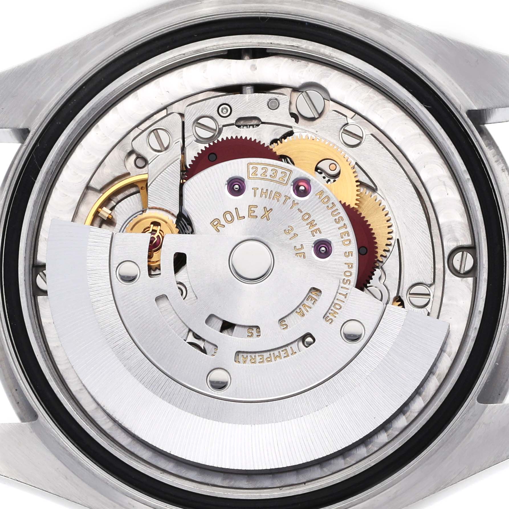 The image shows a close-up of the movement of a Rolex Oyster Perpetual 277200 Women's Stainless Steel Blue Dial watch, highlighting its intricate mechanisms.