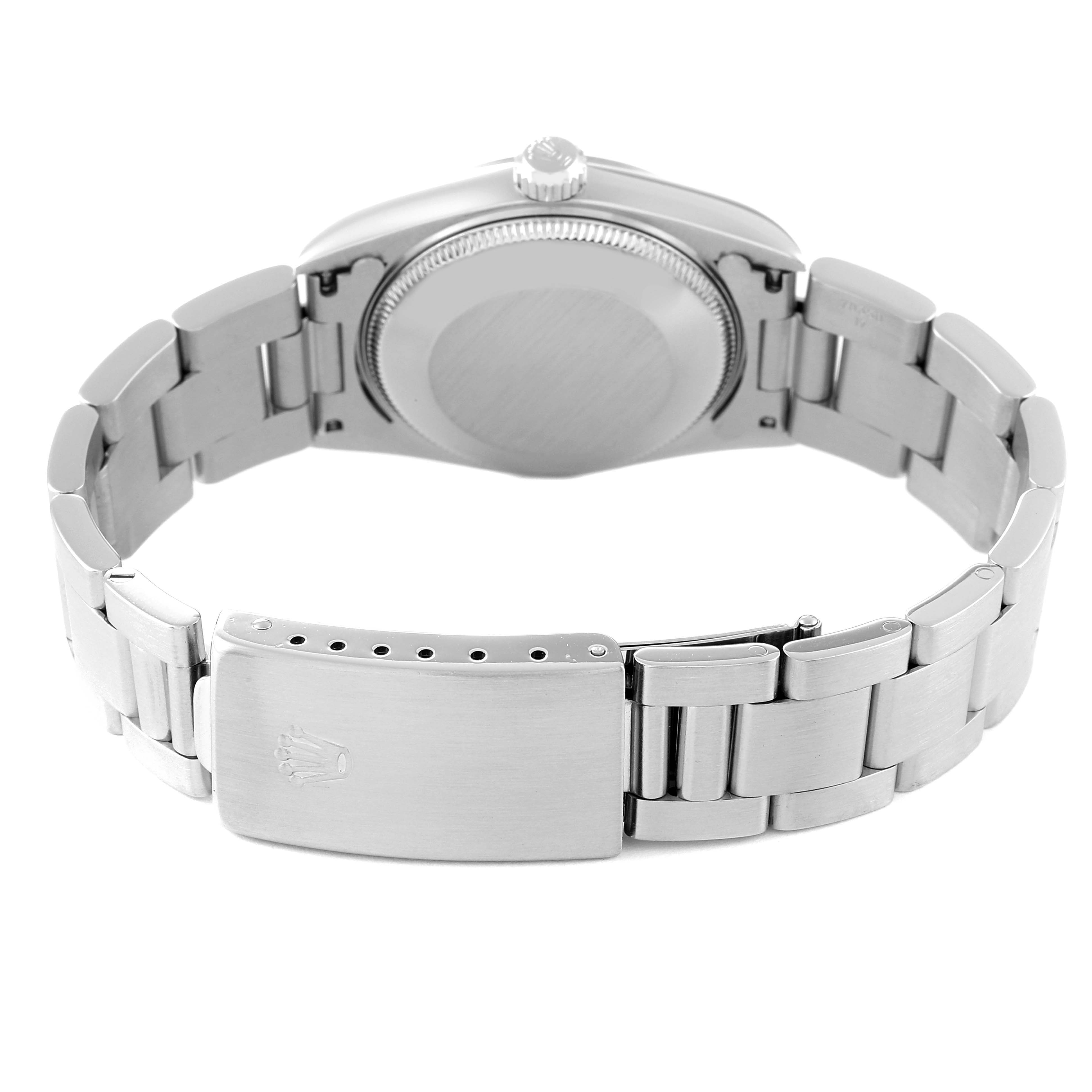 The image shows the back case and bracelet clasp of a Mid-Size Rolex watch from a rear angle.