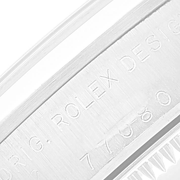 The image shows a close-up of the engraved side of a Mid-Size Rolex watch case.