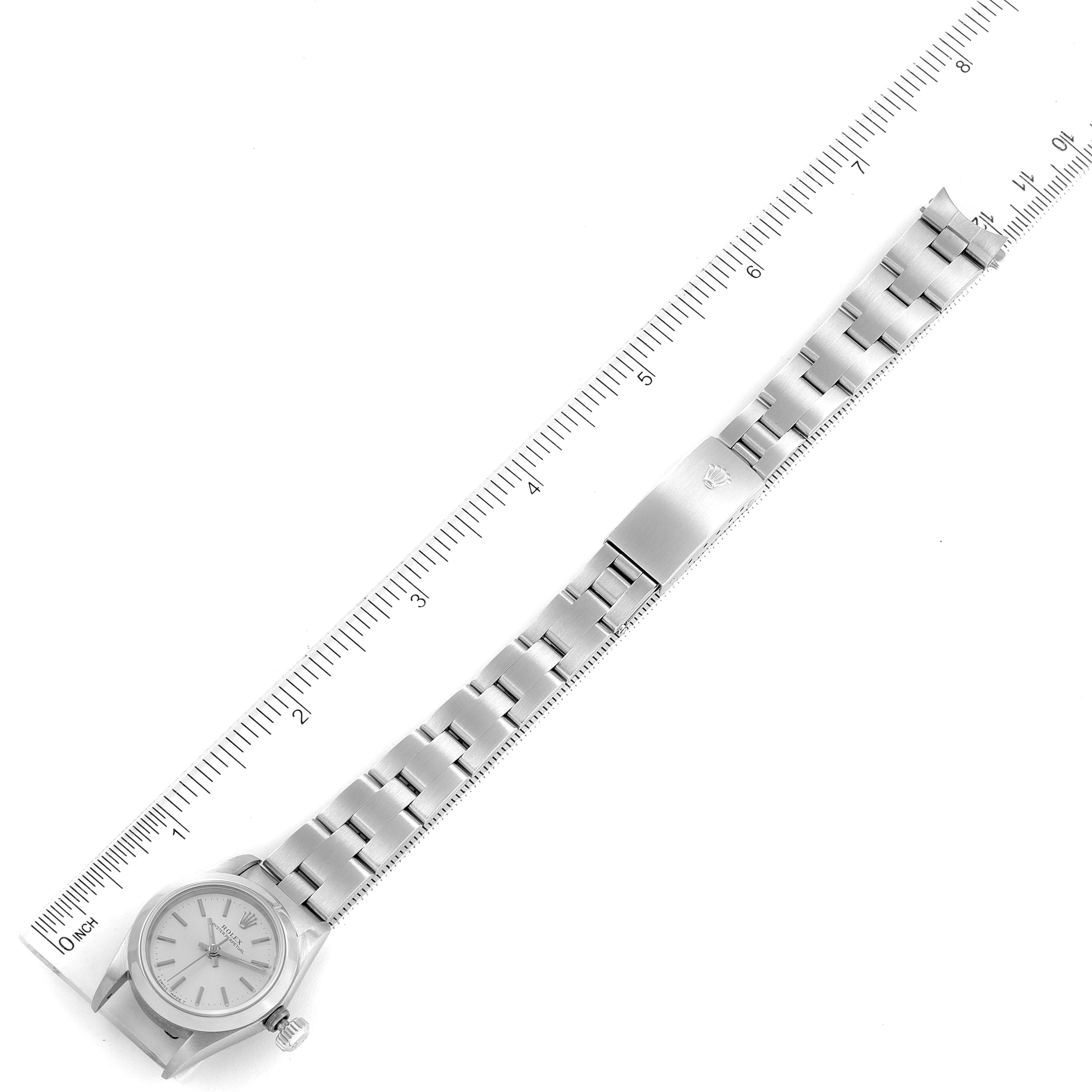 The image shows a top-down view of the Rolex Oyster Perpetual 67180 Women's Stainless Steel Silver Dial 67180 Women's Stainless Steel Silver Dial watch, including the entire bracelet and the dial.