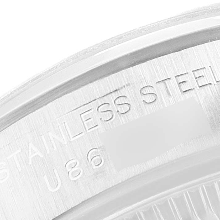 This image shows a close-up view of the stainless steel case back of a Rolex Oyster Perpetual 67180 Women's Stainless Steel Silver Dial 67180 Women's Stainless Steel Silver Dial watch.