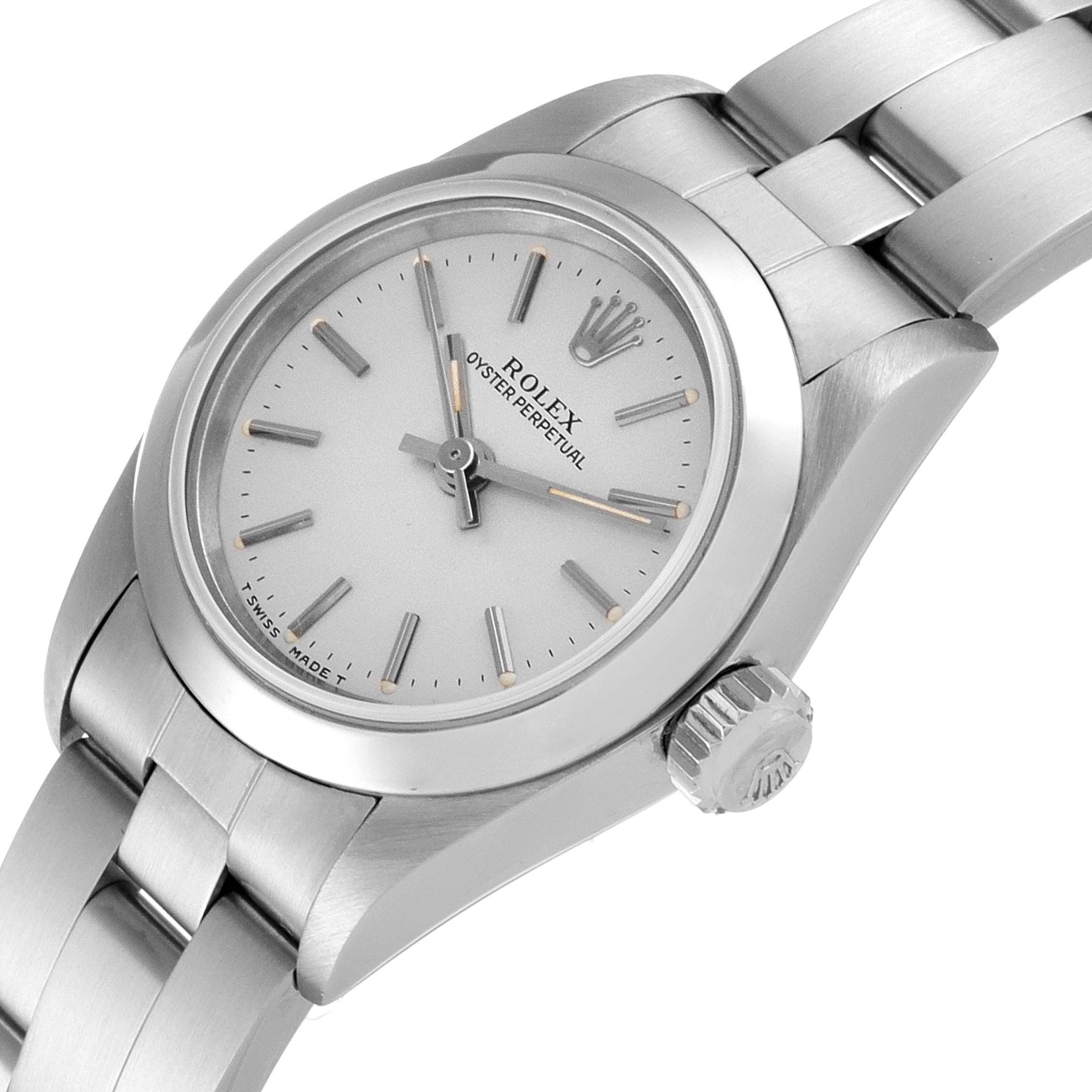 The image shows a Rolex Oyster Perpetual 67180 Women's Stainless Steel Silver Dial 67180 Women's Stainless Steel Silver Dial watch from a slightly angled top view, highlighting the dial, bezel, crown, and bracelet.