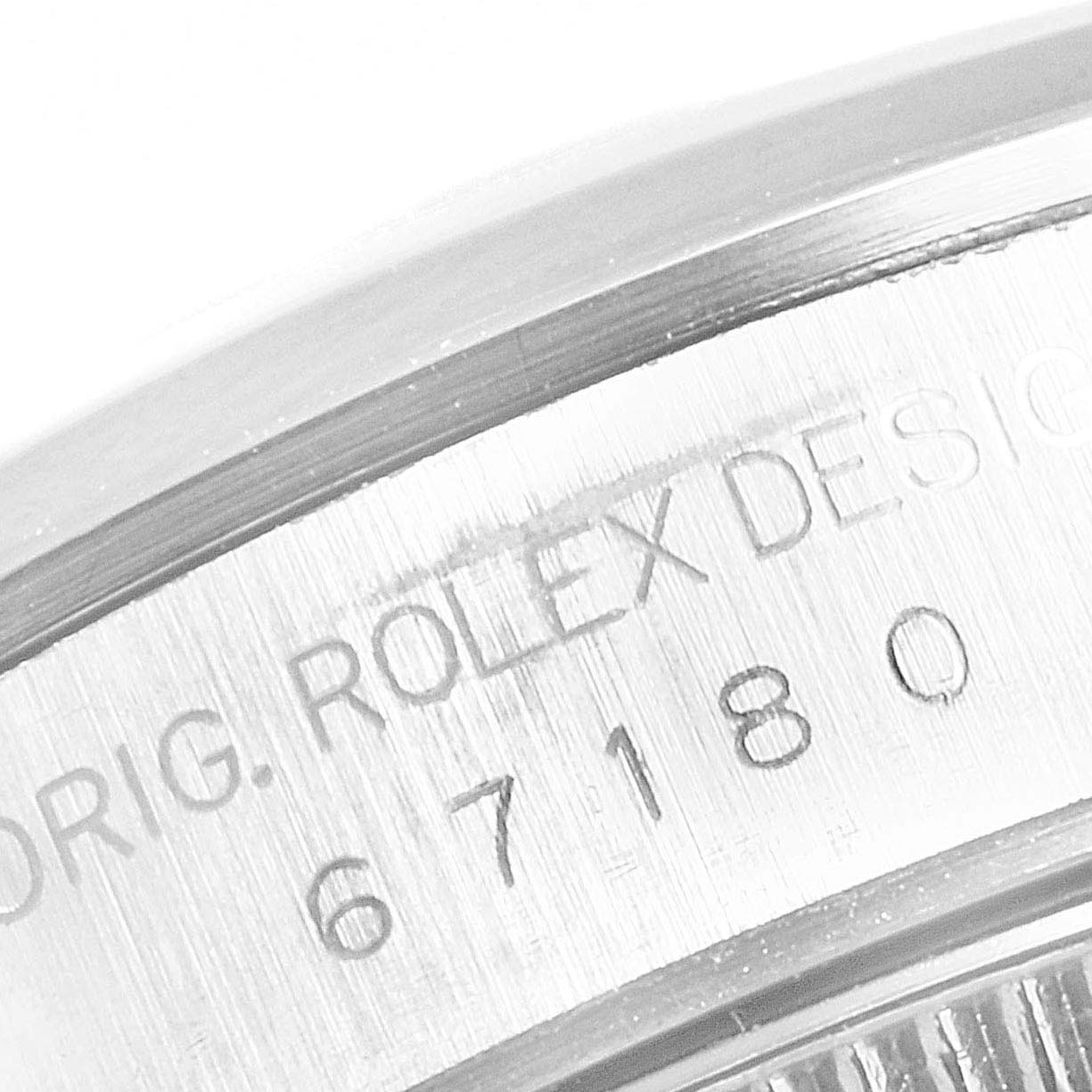 The image showcases a close-up of the case back side of the Rolex Oyster Perpetual 67180 Women's Stainless Steel Silver Dial 67180 Women's Stainless Steel Silver Dial, highlighting its engraved model number.