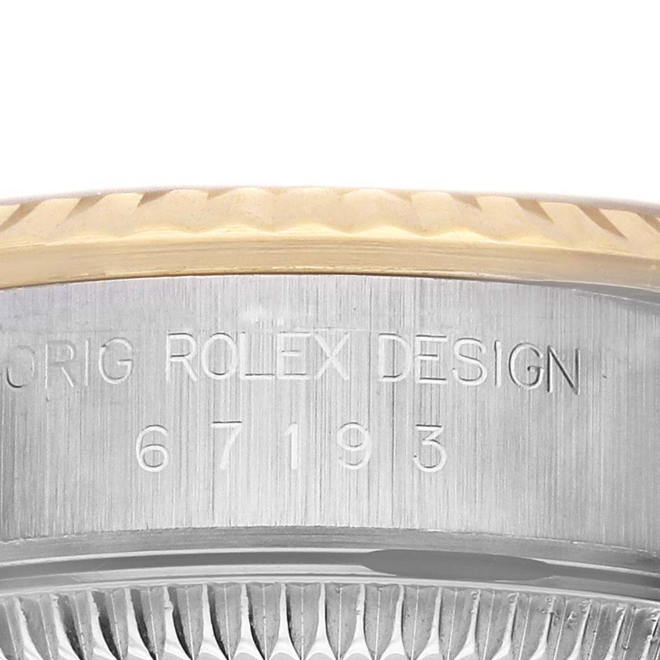 This image shows a close-up of the case side of the Rolex Oyster Perpetual 67193 Women's Steel and Gold (two tone) Champagne Dial 67193 Women's Steel and Gold (two tone) Champagne Dial, featuring the "ORIG ROLEX DESIGN" engraving and model number 67193.