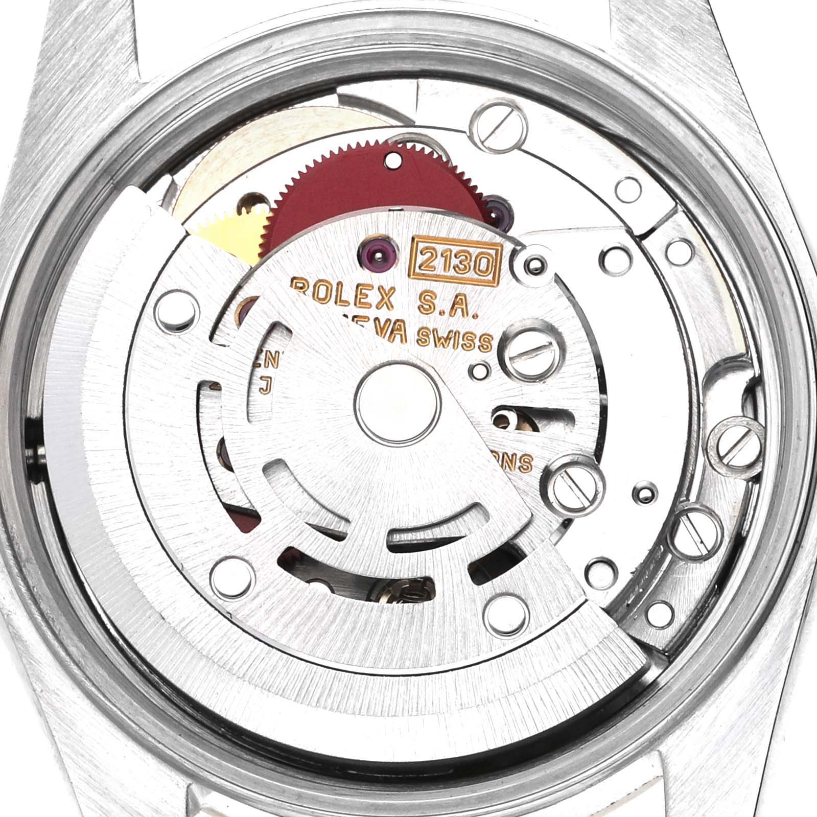 The image shows the movement mechanism of a Rolex Oyster Perpetual 67193 Women's Steel and Gold (two tone) Champagne Dial 67193 Women's Steel and Gold (two tone) Champagne Dial, highlighting gears and engravings from a rear angle.