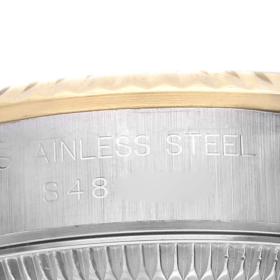 This close-up shows the side of the Rolex Oyster Perpetual 67193 Women's Steel and Gold (two tone) Champagne Dial 67193 Women's Steel and Gold (two tone) Champagne Dial, focusing on the stainless steel and engraved details.