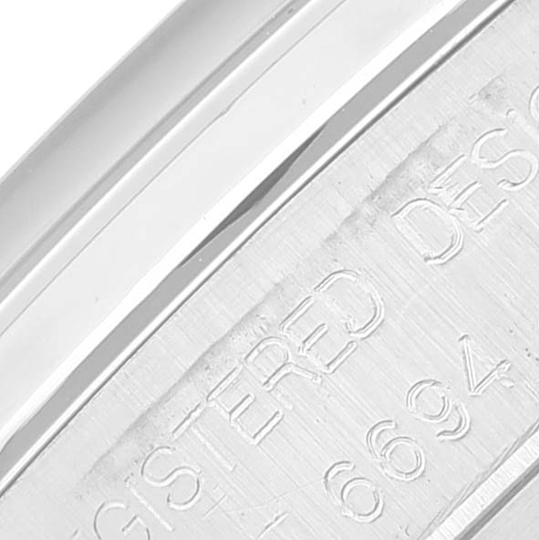 This image shows a close-up angle of the engraved text on the caseback of a Vintage Collection model by Rolex.