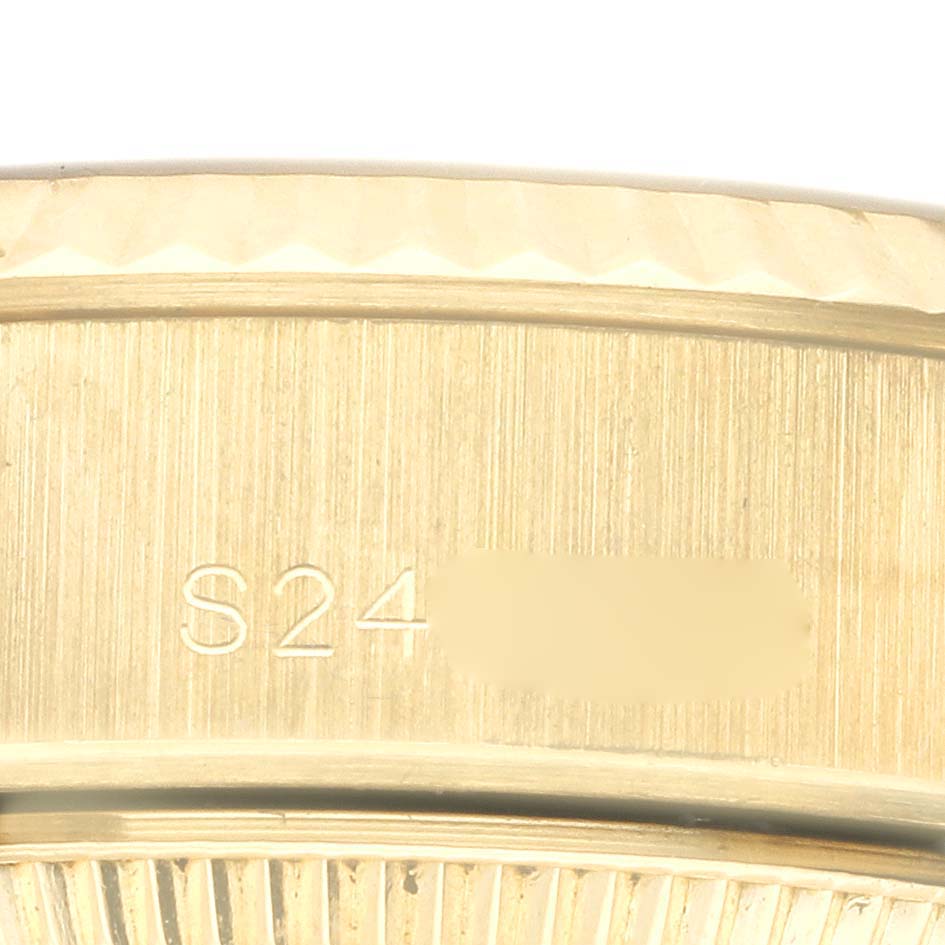 The image shows a close-up of the side of a Rolex President 69178 Women's Yellow Gold Champagne Dial 69178 Women's Yellow Gold Champagne Dial watch, focusing on the engraved details.