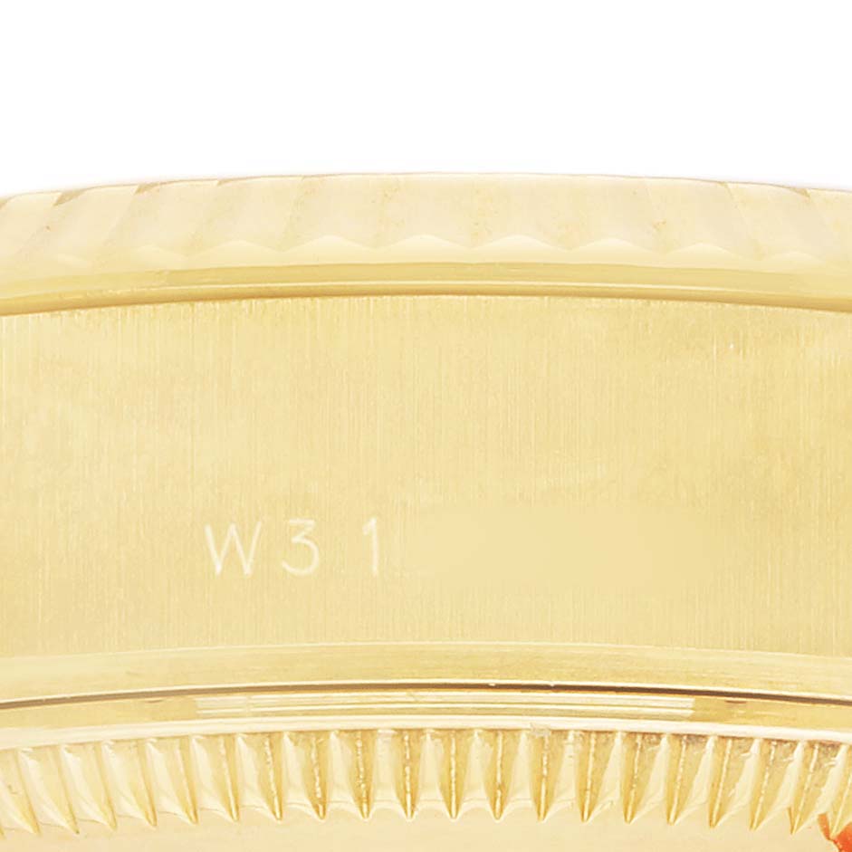 The image shows a close-up of the Rolex Datejust 69178 Women's Yellow Gold Champagne Dial's fluted bezel and case side.