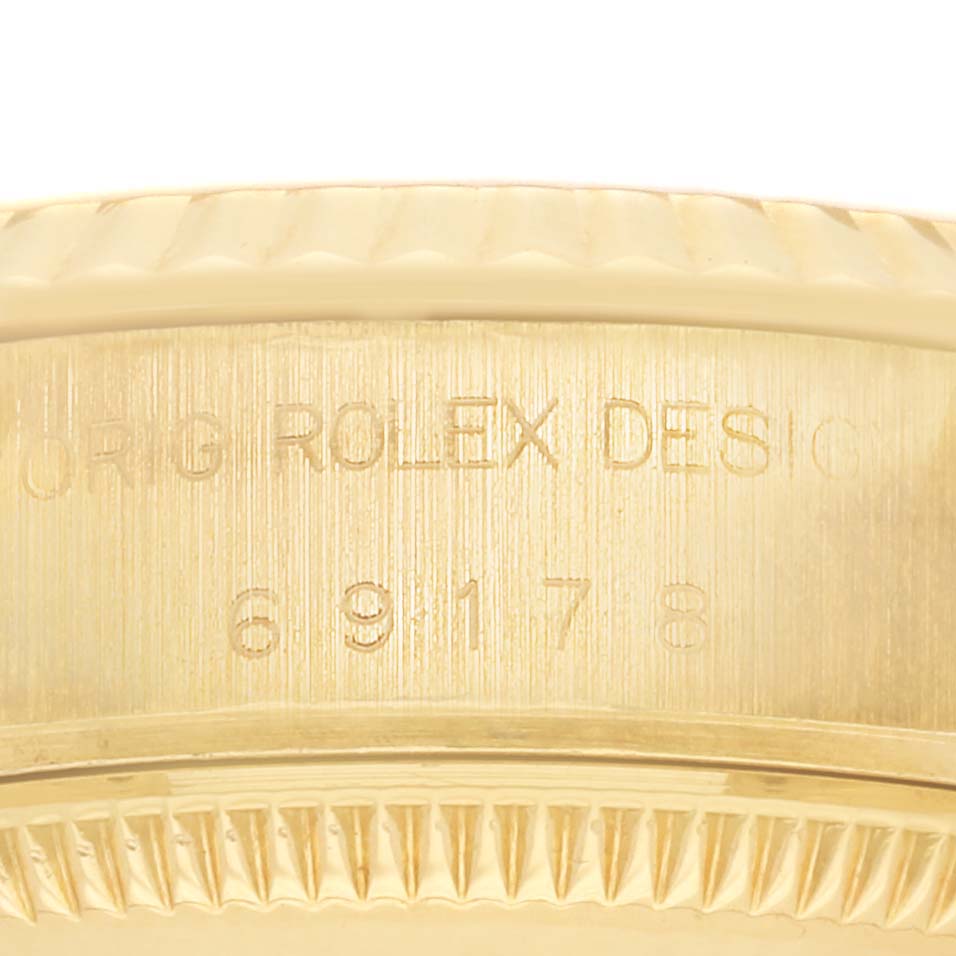 The image shows a close-up of the side of the Rolex Datejust 69178 Women's Yellow Gold Champagne Dial case, highlighting the engraved design details and model number.