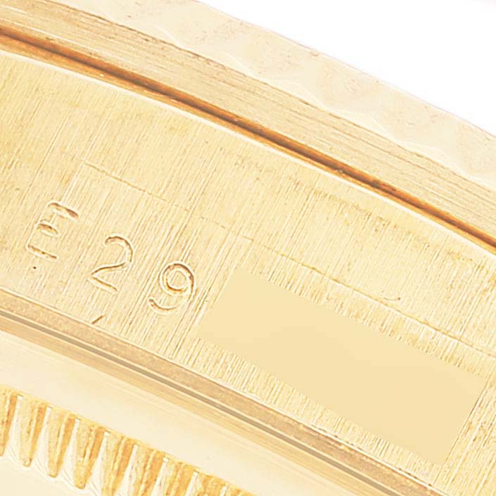 This close-up image shows the engraved inner rim of a Rolex President 18238 Men's Yellow Gold Champagne Dial 18238 Men's Yellow Gold Champagne Dial model watch.