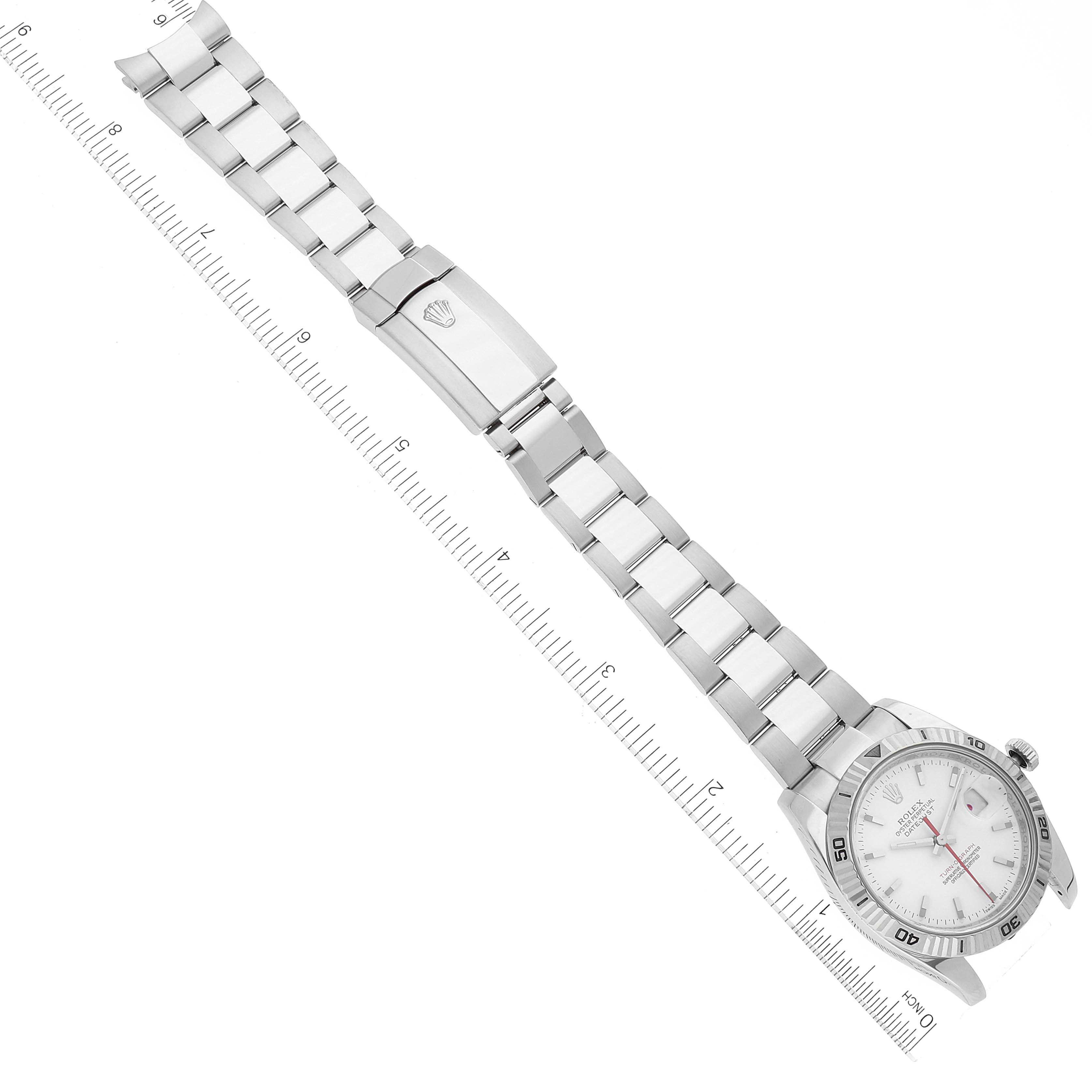 The image shows a Rolex Turn-o-Graph 116264 Men
s Stainless Steel White Dial 116264 Men
s Stainless Steel White Dial watch laid flat, displaying its bracelet, clasp, and face at an angled top-down view with a ruler for scale.