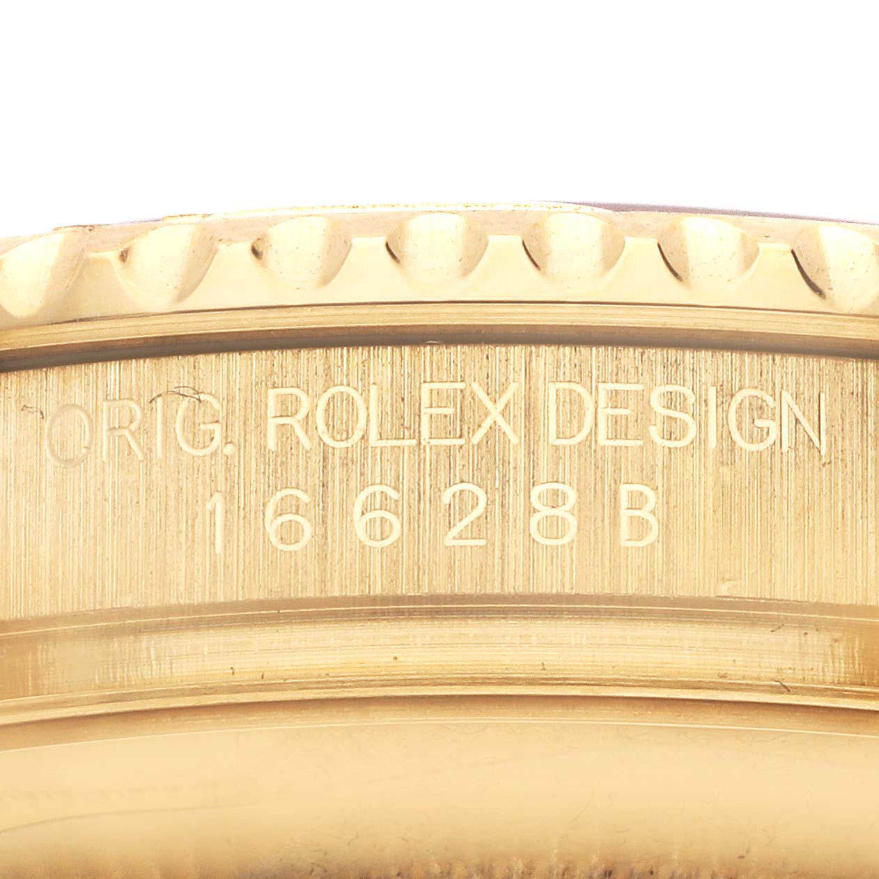 The image shows a close-up of the engraved side of a Rolex Yacht-Master 16628 Men's Yellow Gold White Dial 16628 Men's Yellow Gold White Dial case, displaying the model details.
