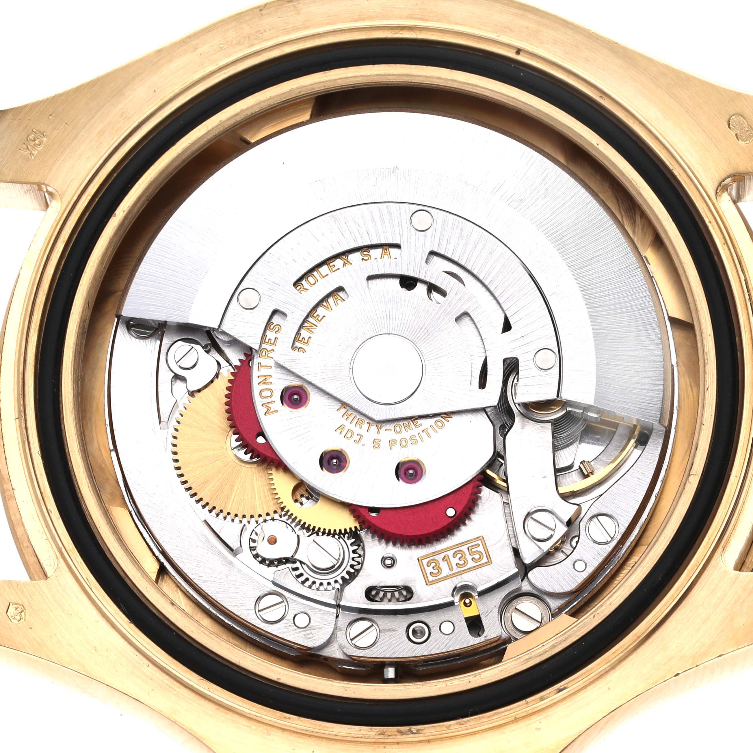The image shows the internal mechanism of the Rolex Yacht-Master 16628 Men's Yellow Gold White Dial 16628 Men's Yellow Gold White Dial watch, displaying gears and components from a top-down angle.
