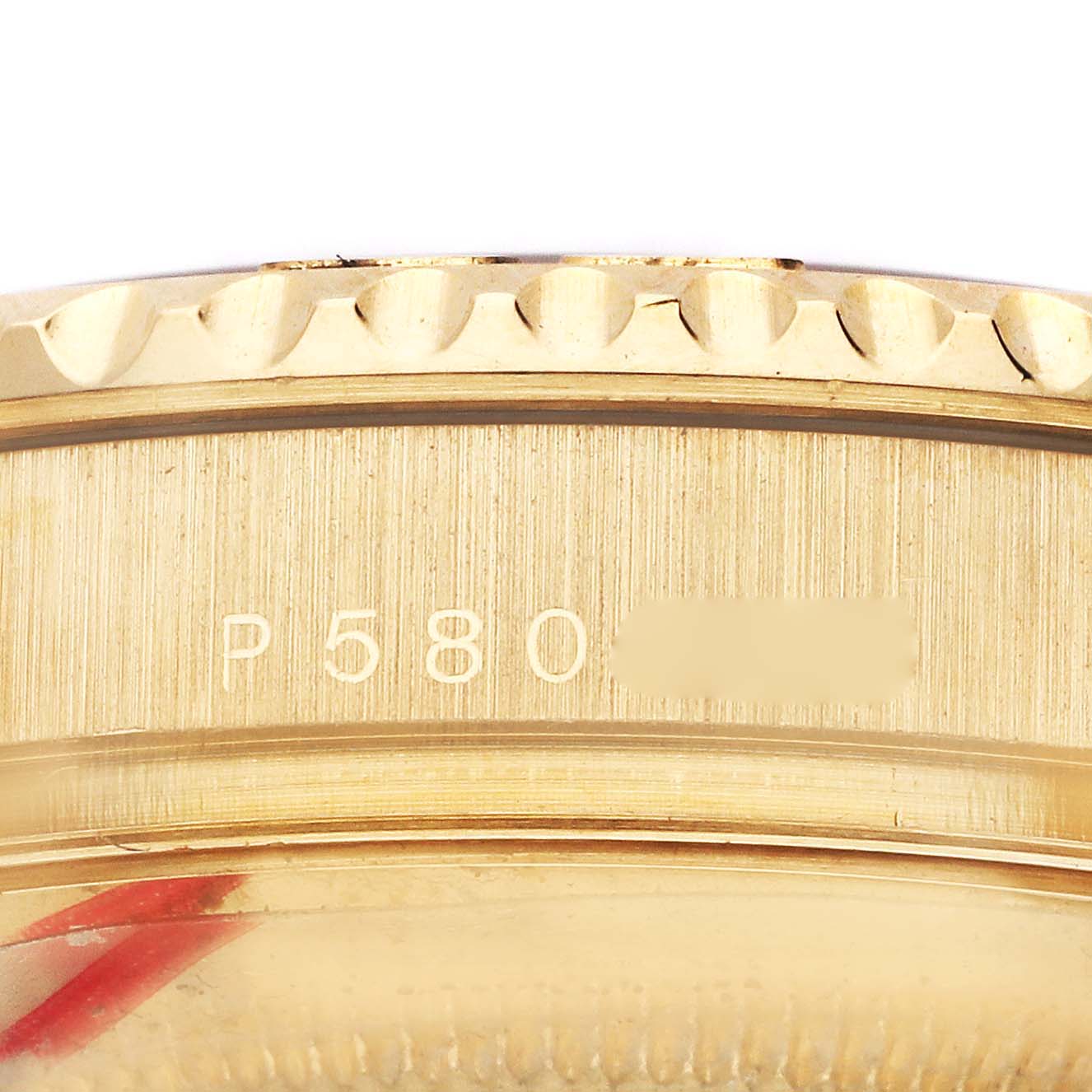 The image shows the side profile of a Rolex Yacht-Master 16628 Men's Yellow Gold White Dial 16628 Men's Yellow Gold White Dial watch, focusing on the bezel and engraved serial number.