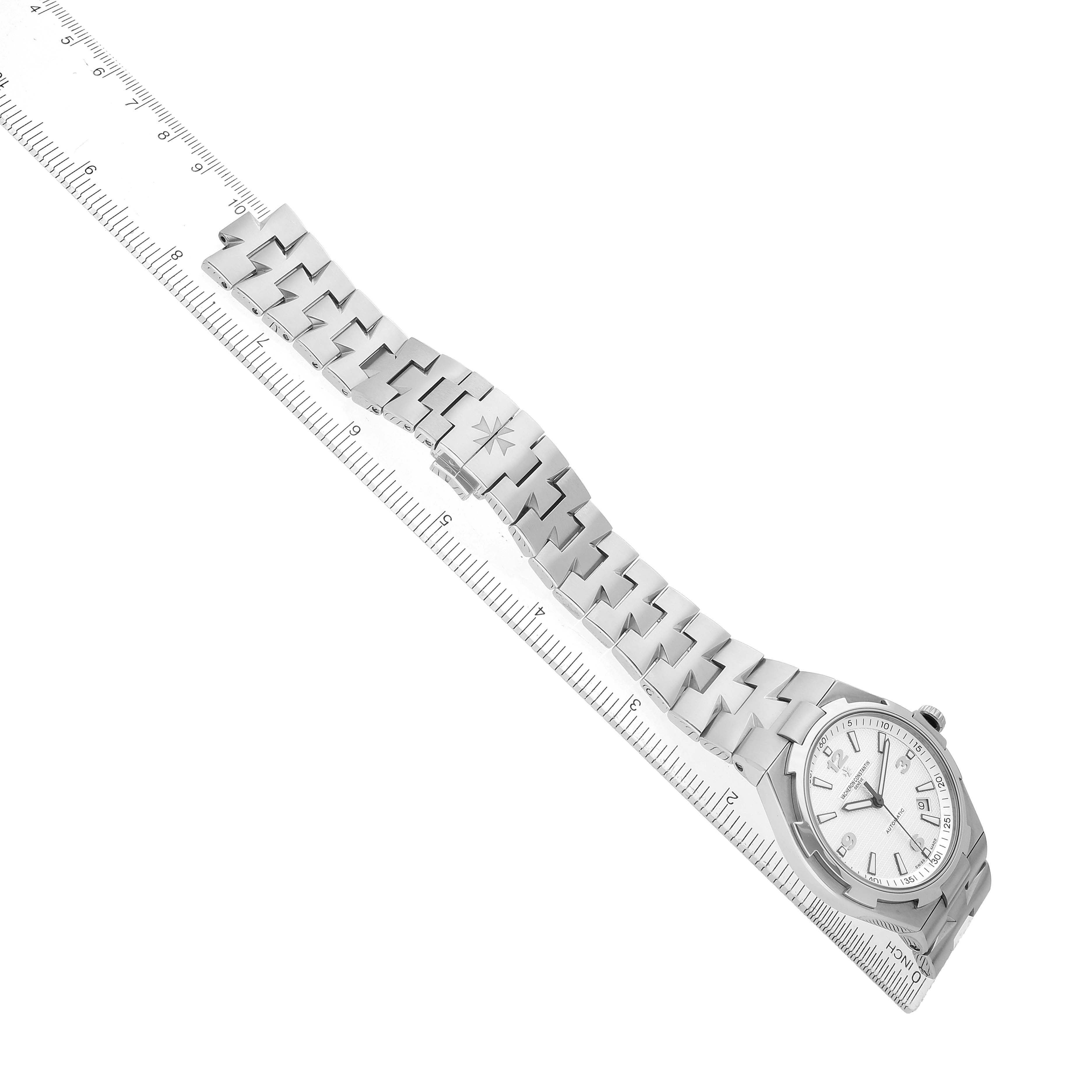 The Vacheron Constantin Overseas 47040 Men's Stainless Steel Silver Dial watch is shown at an angled top view, displaying the face and full bracelet aligned with a ruler.