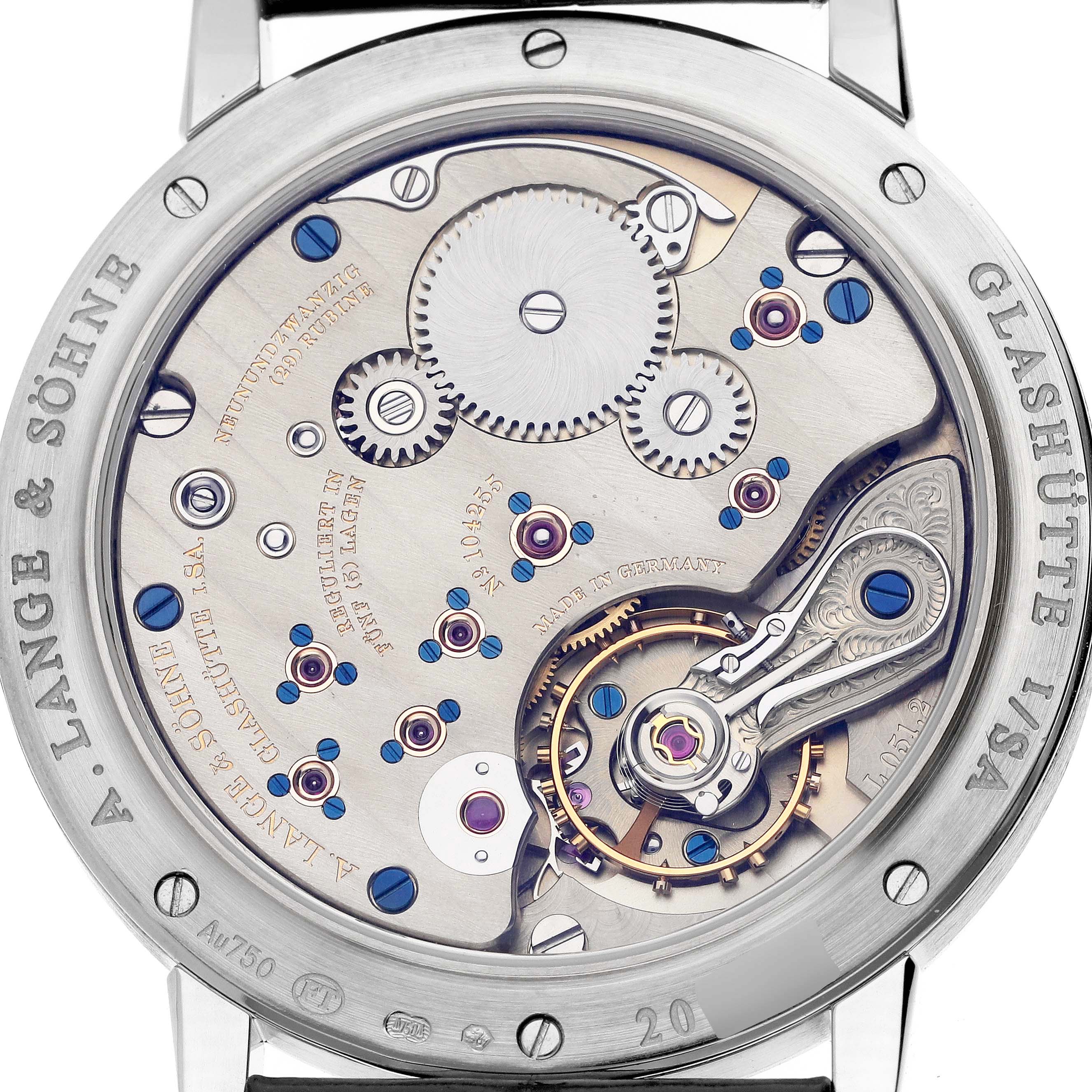 The image shows the back of the A. Lange 
Sohne 1815 234.026 Men
s White Gold Silver Dial watch, highlighting its intricate movement and gears.