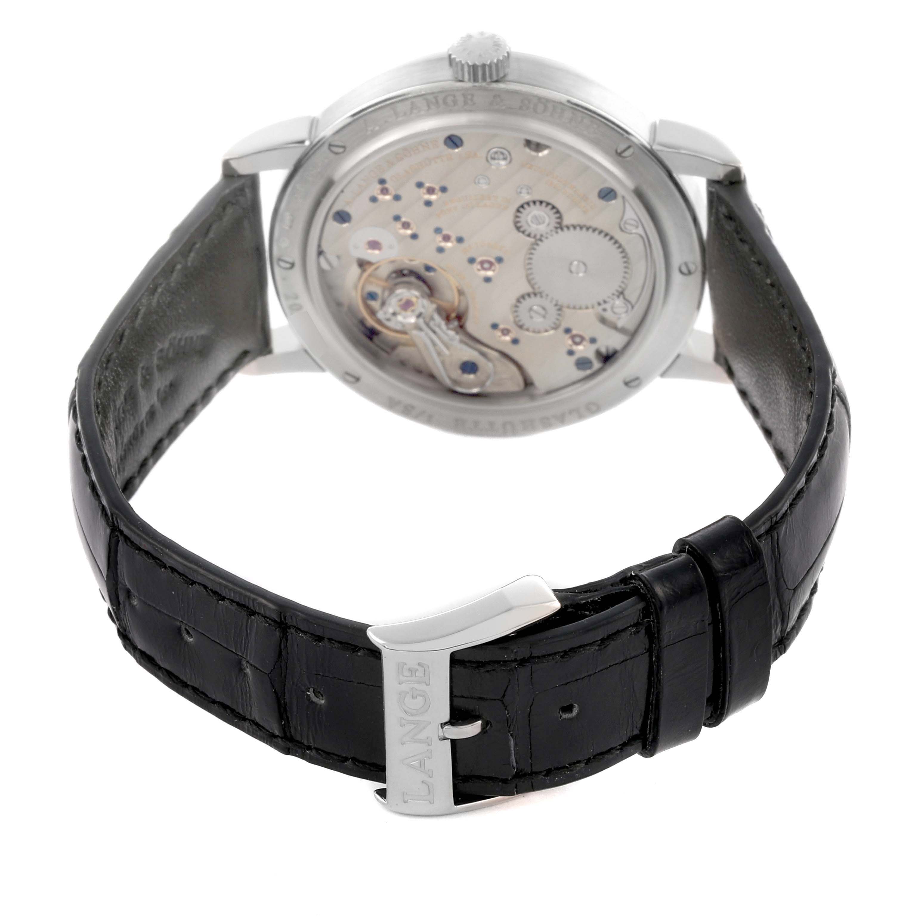 The image shows the back view of the A. Lange 
Sohne 1815 234.026 Men
s White Gold Silver Dial model, highlighting the movement and leather strap.