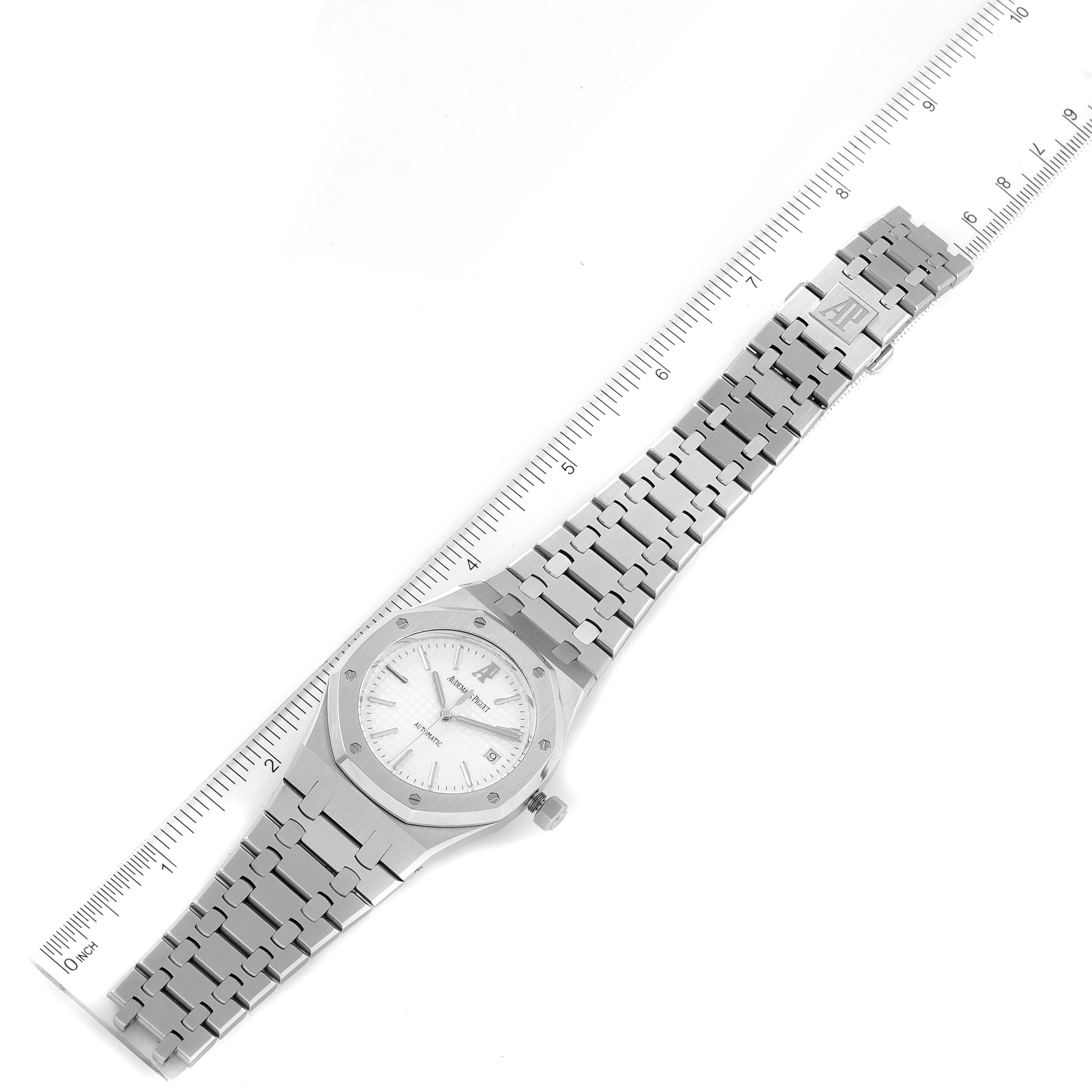 The image shows an Audemars Piguet Royal Oak 15300ST.00.1220ST.01 Men's Stainless Steel White Dial 15300ST.00.1220ST.01 Men's Stainless Steel White Dial watch from a top-down angle, featuring the face, bezel, and entire bracelet next to a ruler for scale.