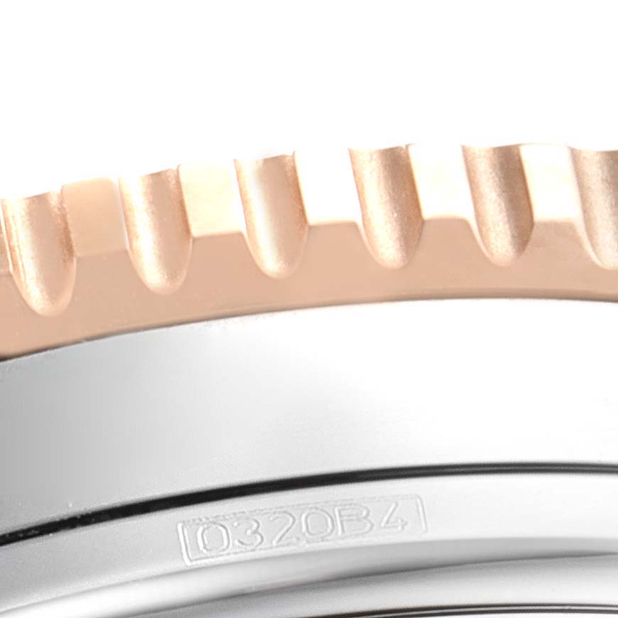 The image shows a close-up of the textured bezel and part of the case of a Breitling Navitimer U13324211B1X1 Men's Steel and Gold (two tone) Black Dial U13324211B1X1 Men's Steel and Gold (two tone) Black Dial watch.