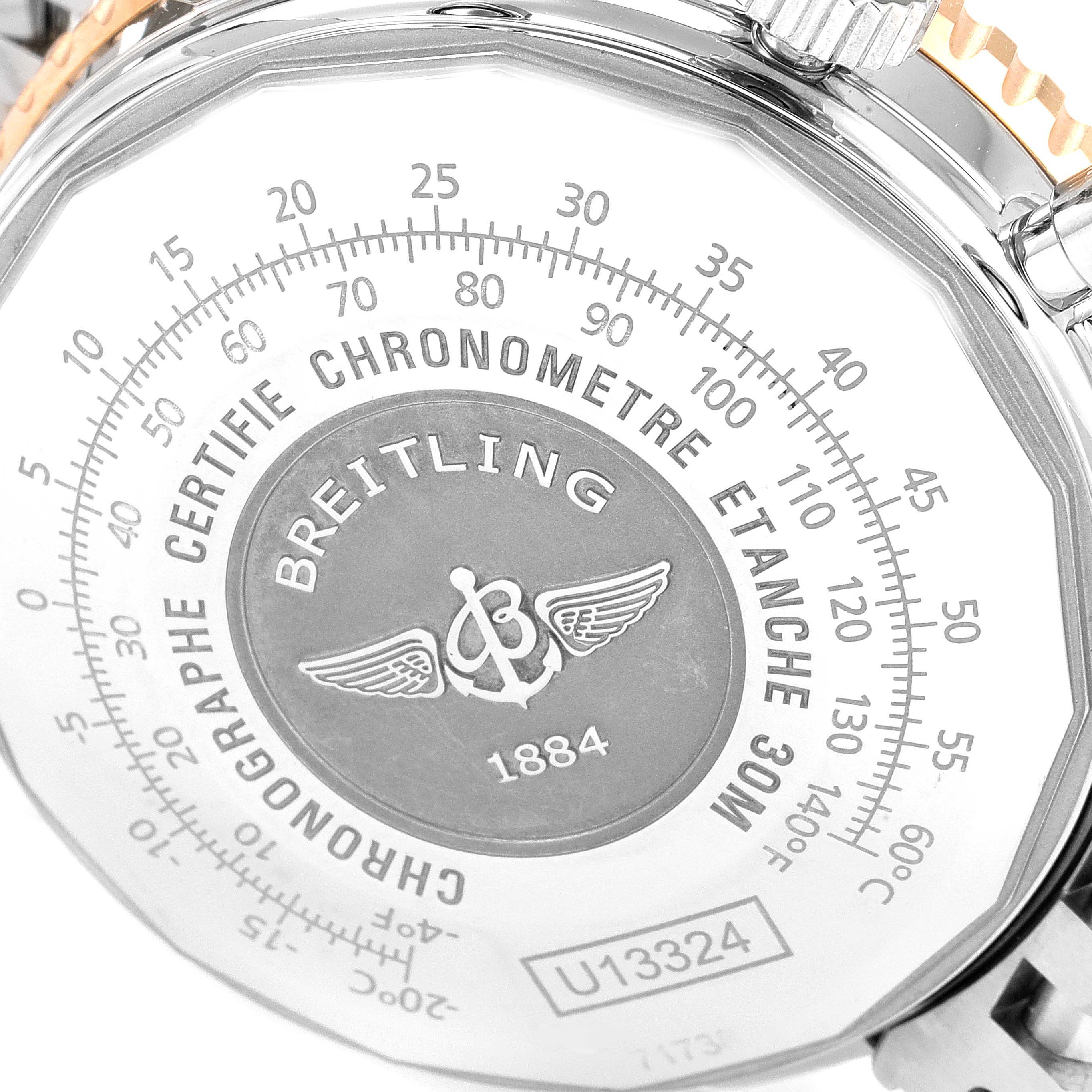 The image shows the back case of a Breitling Navitimer U13324211B1X1 Men's Steel and Gold (two tone) Black Dial U13324211B1X1 Men's Steel and Gold (two tone) Black Dial watch, highlighting its inscriptions and design details.