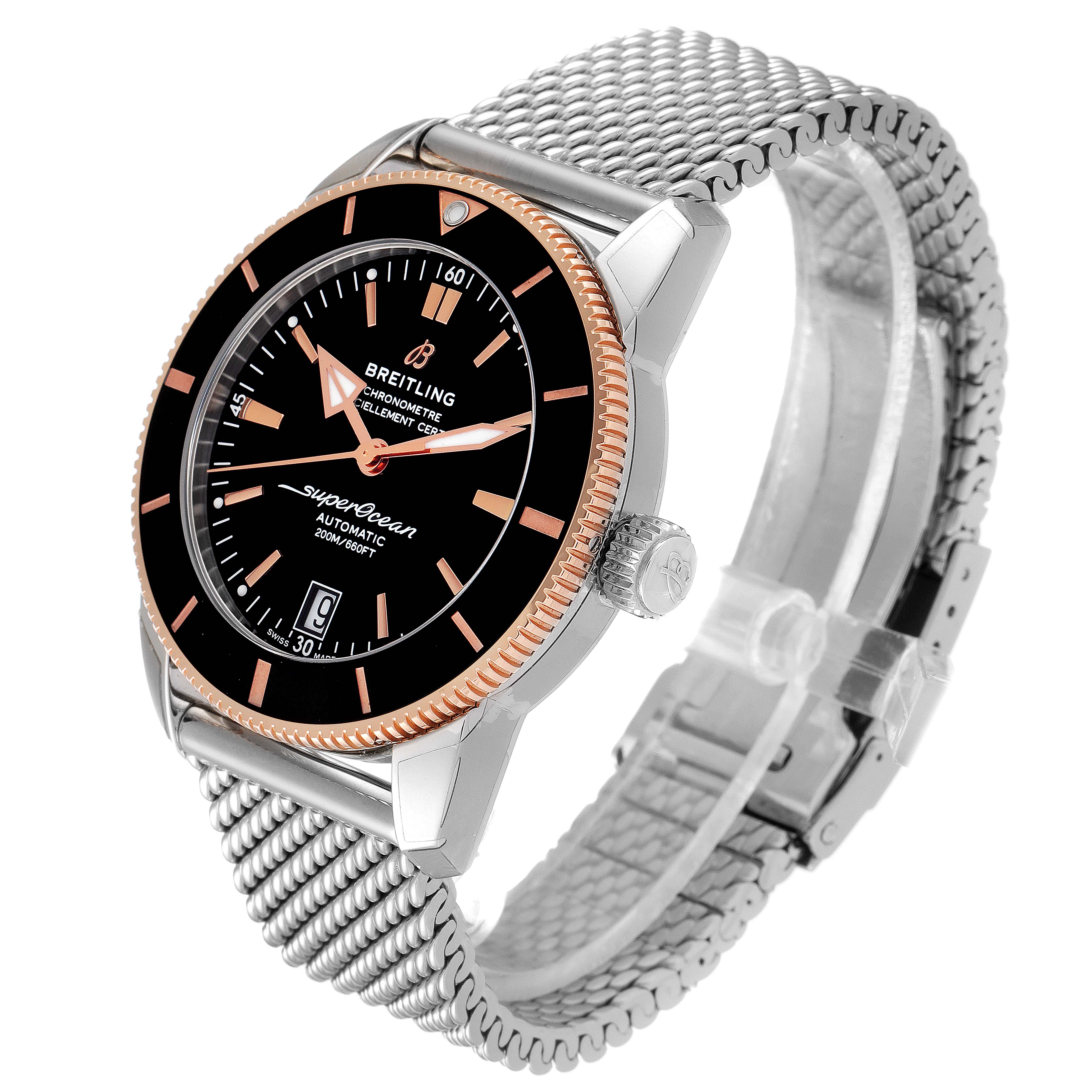The Breitling Superocean UB201012/BG53/154A Men
s Steel and Gold (two tone) Black Dial UB201012/BG53/154A Men
s Steel and Gold (two tone) Black Dial watch is shown at a three-quarter angle, highlighting its black dial, rose gold bezel, and metal mesh bracelet.