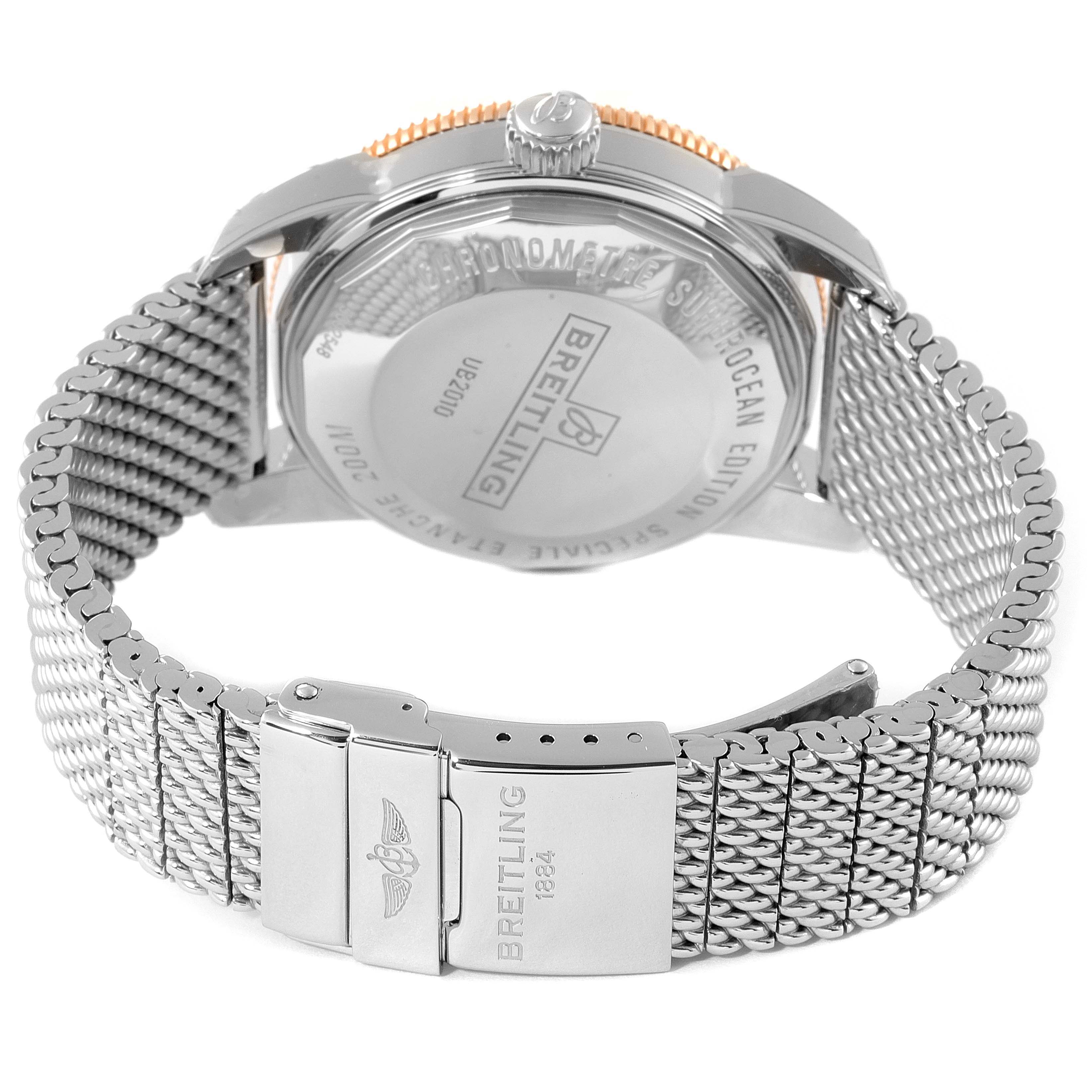 The image shows the back view of a Breitling Superocean UB201012/BG53/154A Men
s Steel and Gold (two tone) Black Dial UB201012/BG53/154A Men
s Steel and Gold (two tone) Black Dial model watch, highlighting its clasp and mesh band.