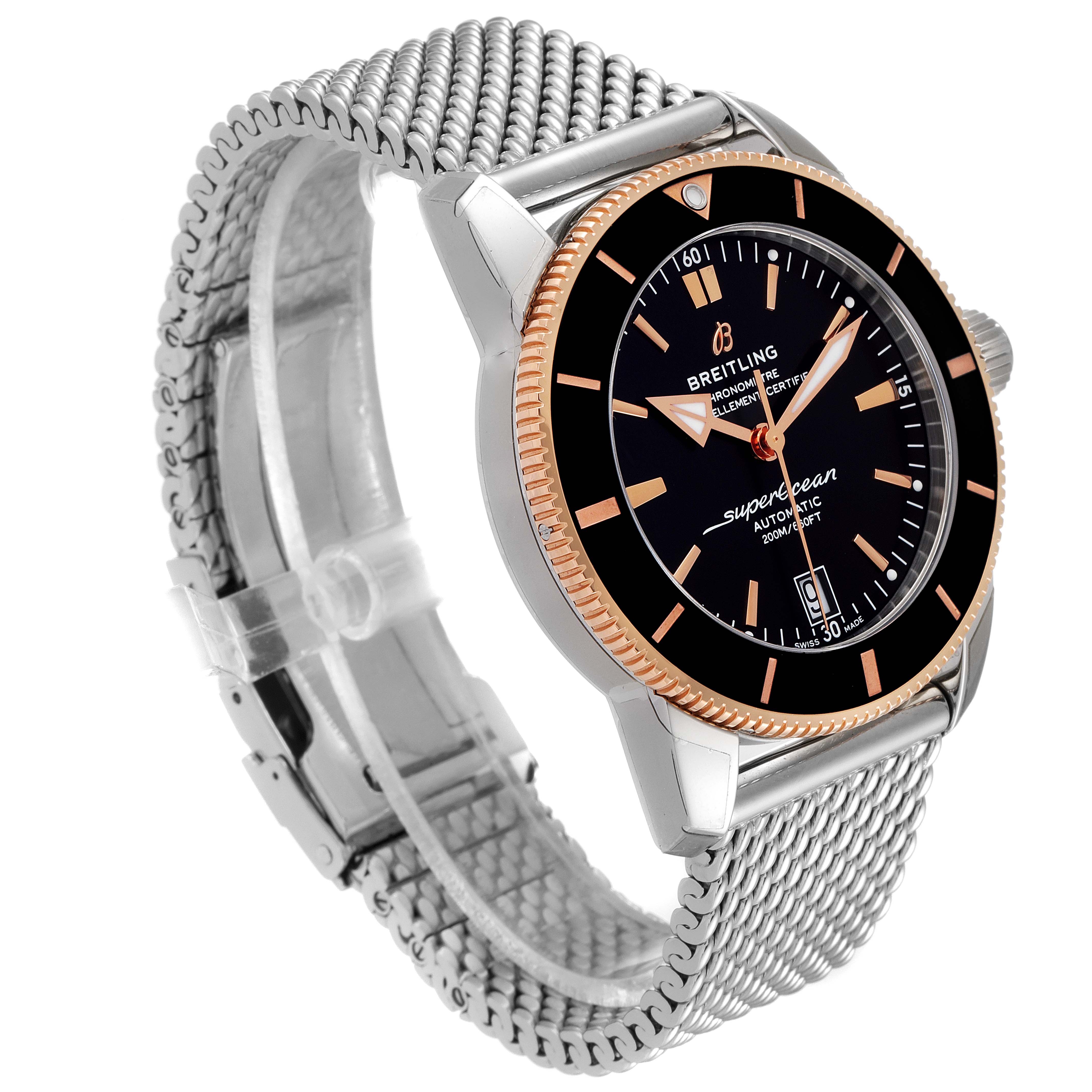 This image shows a side angle of the Breitling Superocean UB201012/BG53/154A Men
s Steel and Gold (two tone) Black Dial UB201012/BG53/154A Men
s Steel and Gold (two tone) Black Dial watch, displaying the face, bezel, crown, and metal mesh strap.