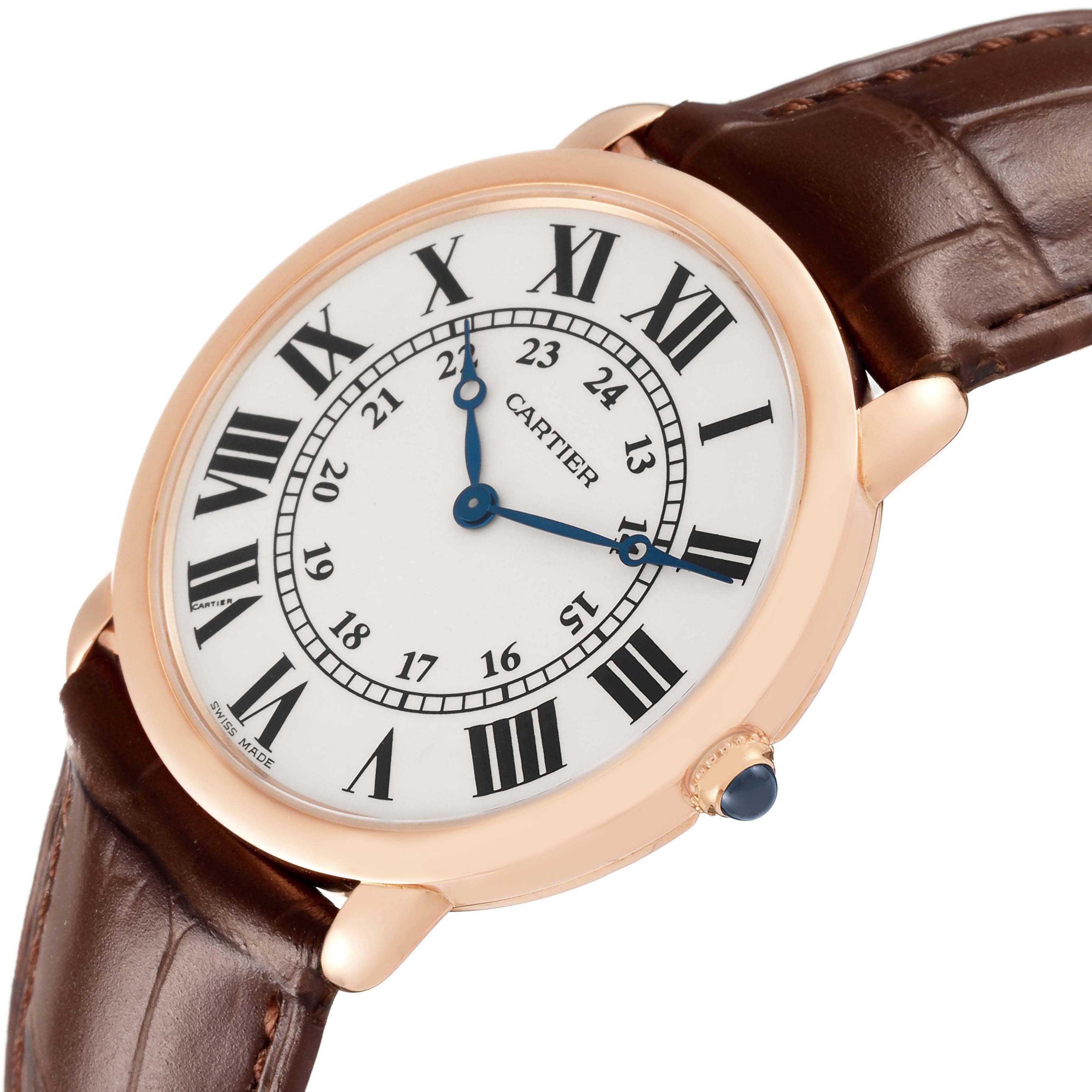 The Cartier Ronde W6800251 Men's Rose Gold Silver Dial watch is shown at an angle displaying its face, Roman numerals, blue hands, and brown leather strap.