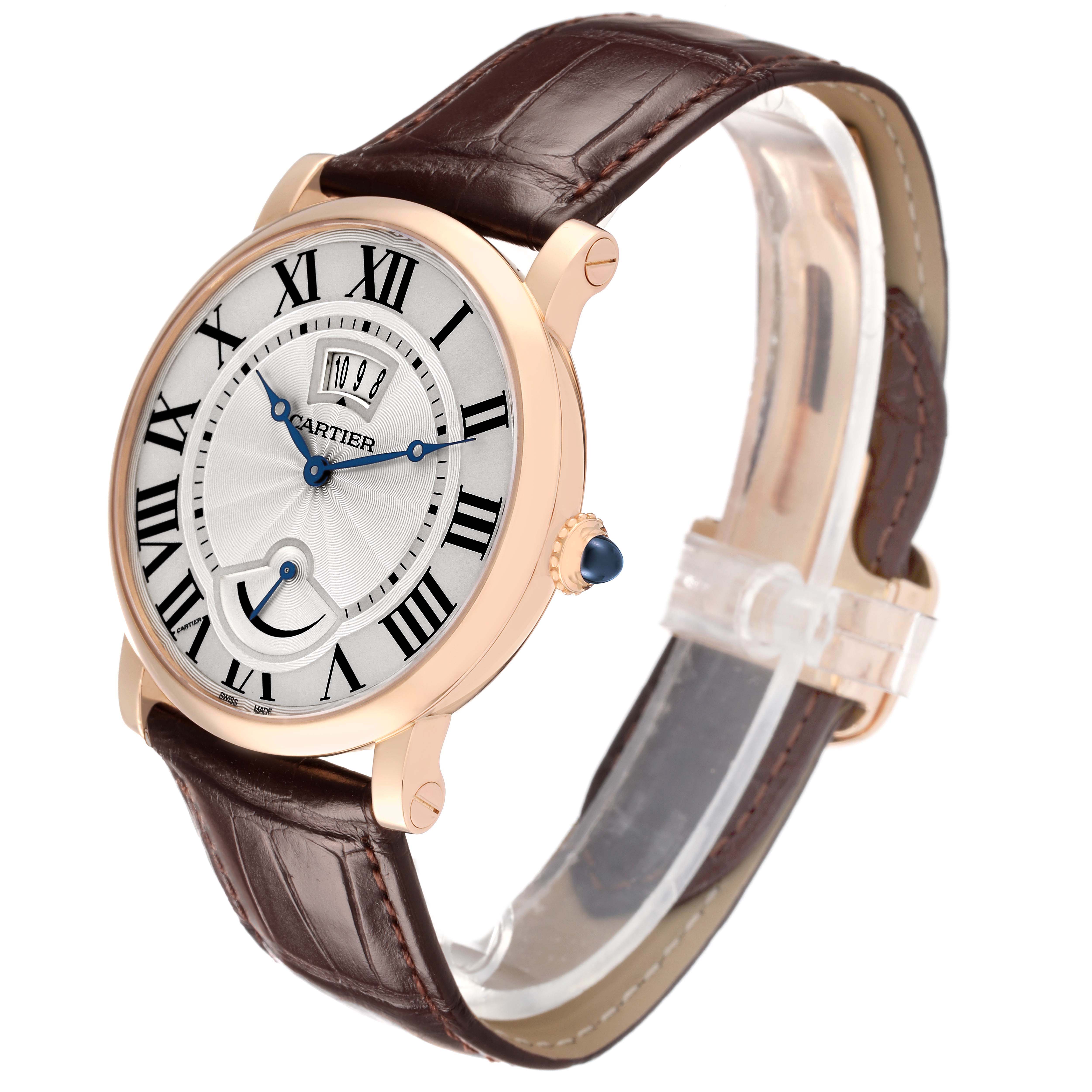 The Rotonde de Cartier watch is shown at an angled side perspective, highlighting the face, Roman numerals, and brown leather strap.