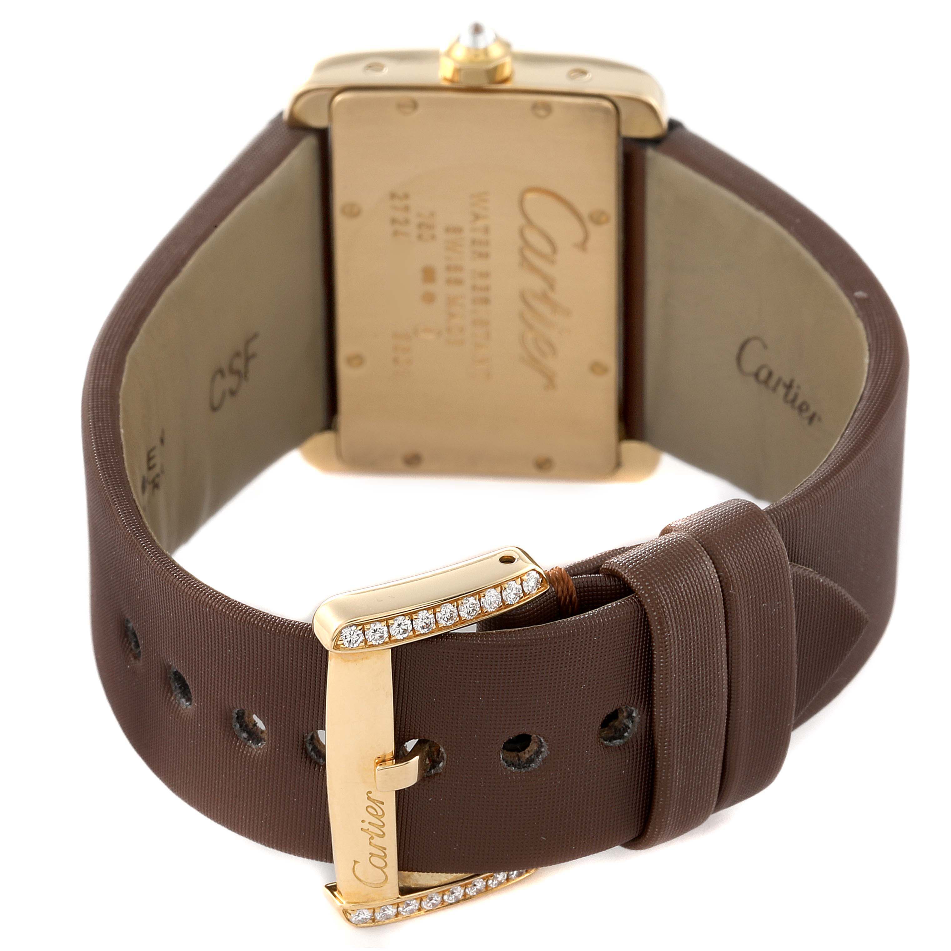 This image shows the back of a Cartier Tank Divan WA301071 Women
s Yellow Gold Silver Dial WA301071 Women
s Yellow Gold Silver Dial watch, highlighting its caseback and brown strap with a jeweled buckle.