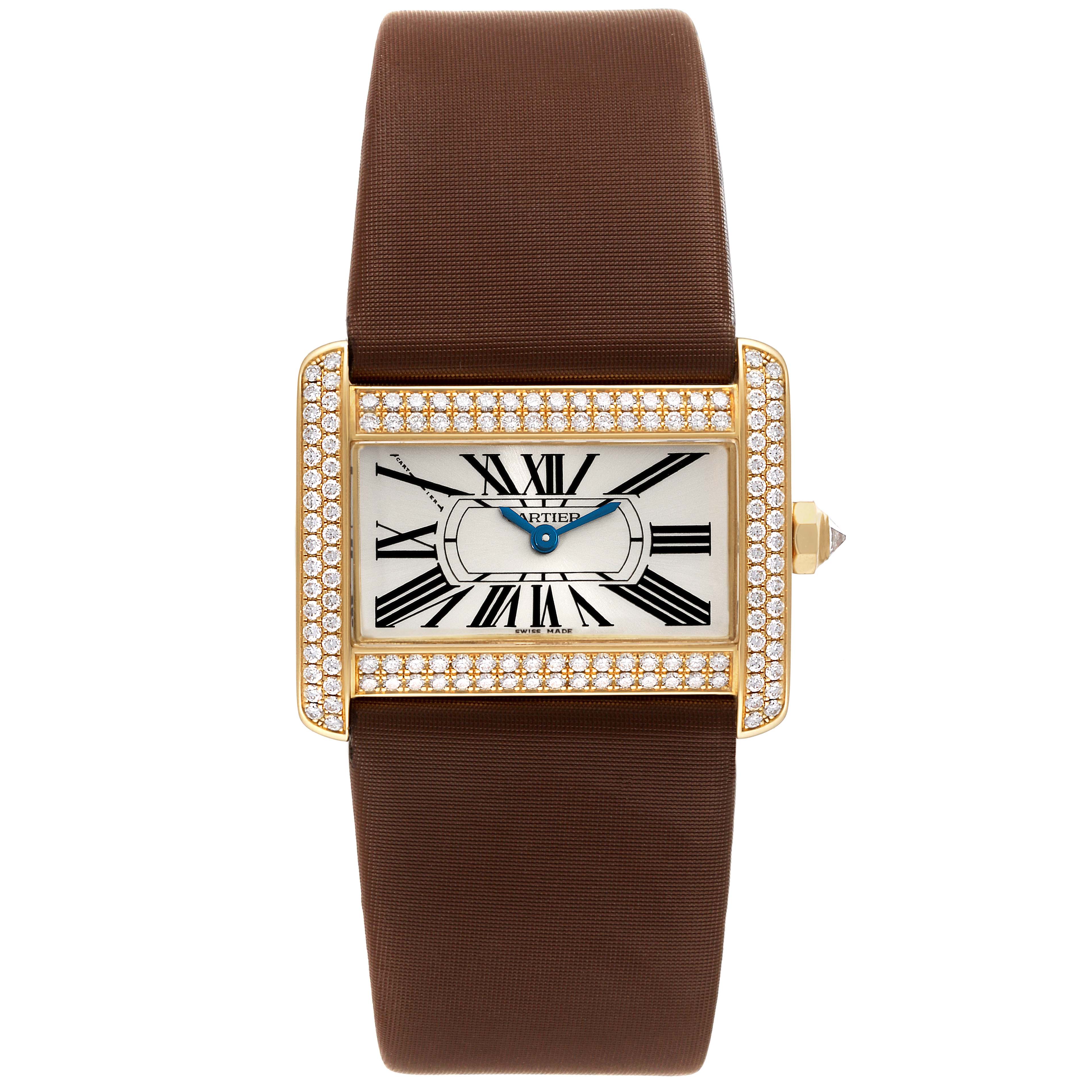 The image shows a Tank Divan watch by Cartier from a front angle, featuring a rectangular face, diamond bezel, and brown strap.