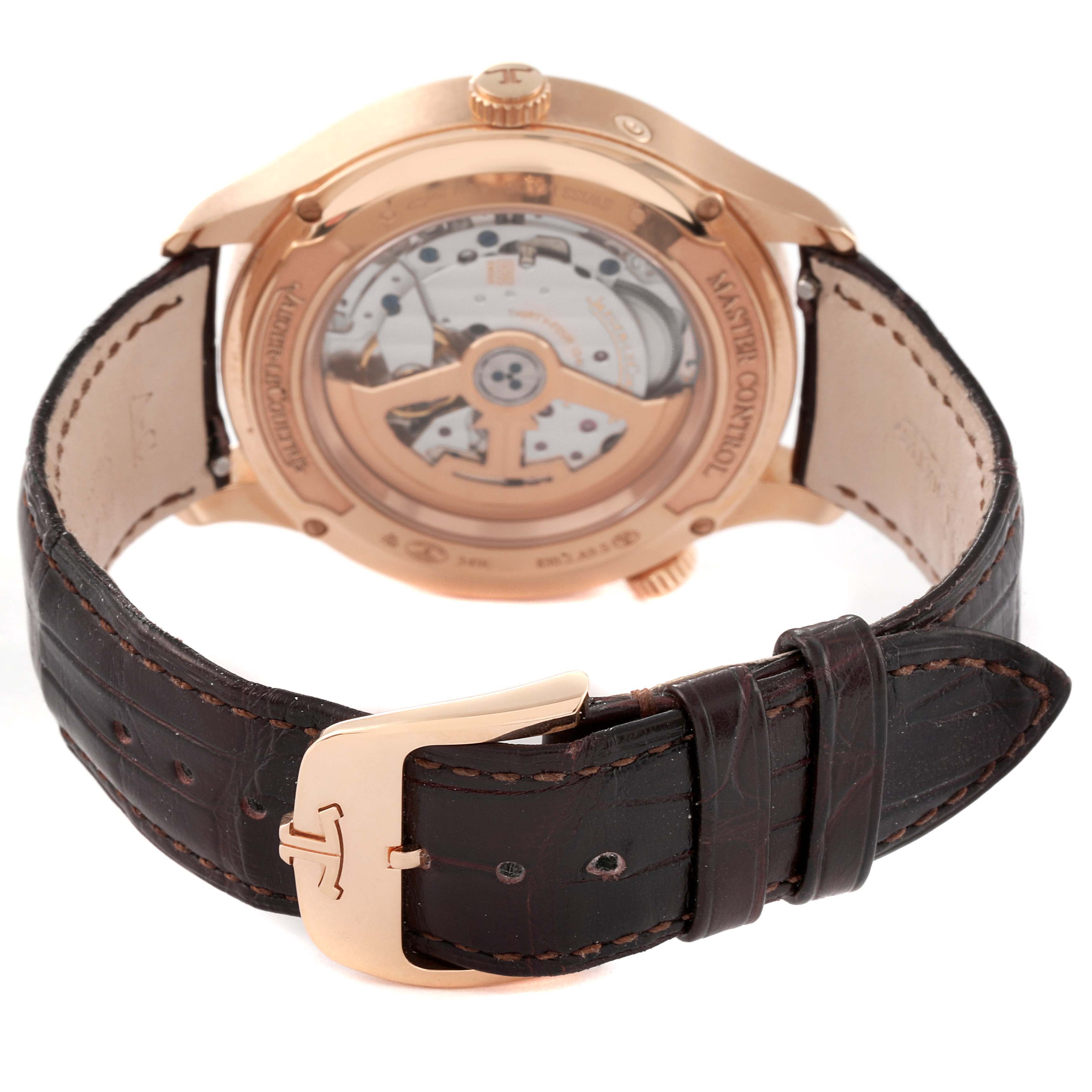 This image shows the back view of a Jaeger LeCoultre Master Q4122520 Men's Rose Gold Silver Dial Q4122520 Men's Rose Gold Silver Dial model watch, highlighting the movement mechanism and the leather strap with a buckle.