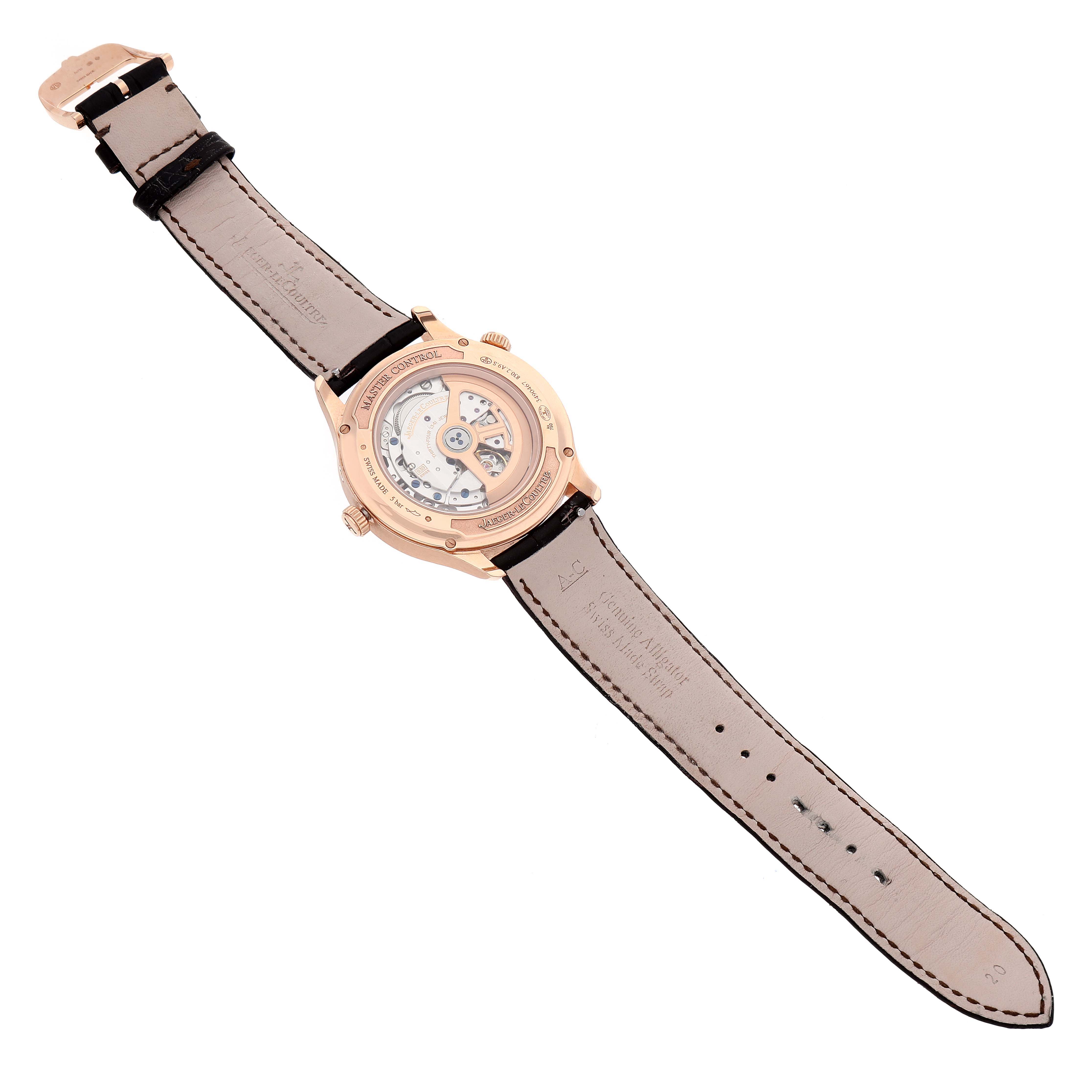 The image shows the back view of a Jaeger LeCoultre Master Q4122520 Men's Rose Gold Silver Dial Q4122520 Men's Rose Gold Silver Dial model watch, revealing its mechanical movement and leather strap.